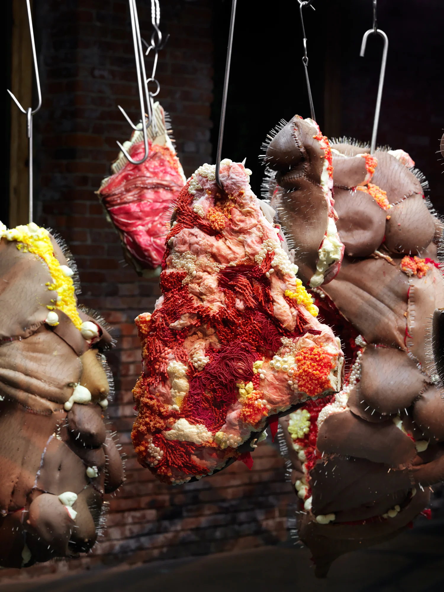 Rack of those Ravaged and Unconsenting Silicone, Insulation foam, Glass beads, Fiber Glass insulation, Steel meat hooks, Steel pins, Pearls, 8'x8'x8' 2017