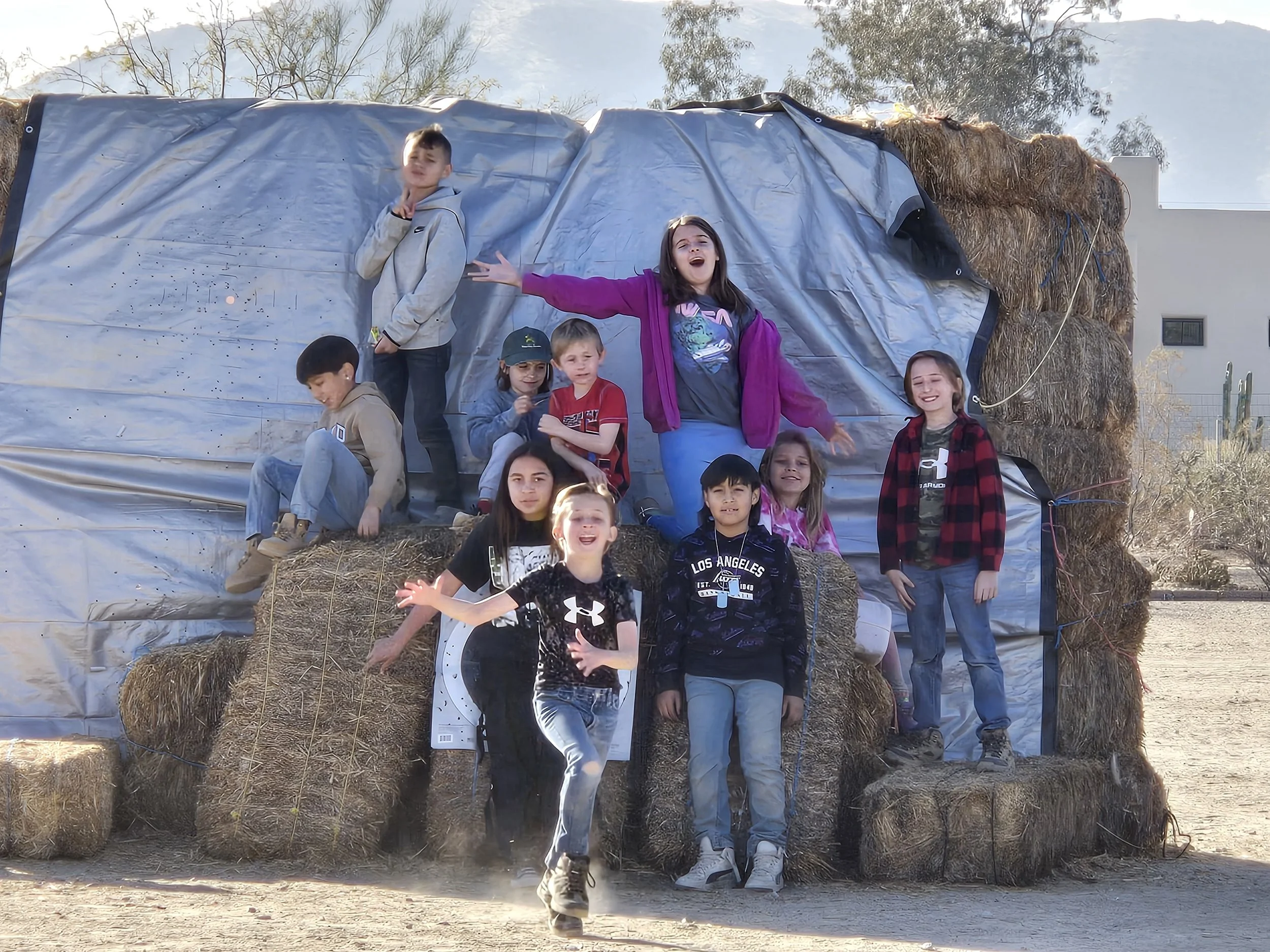2024 winter camp kids on strawbales.jpg