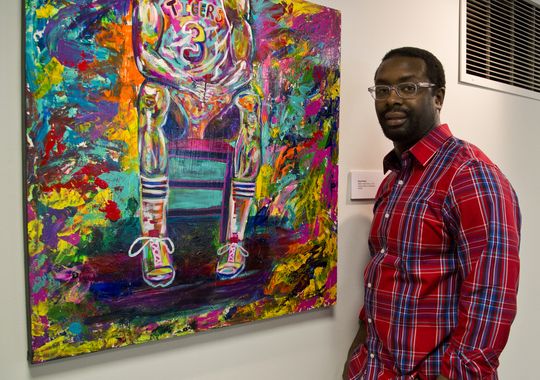Boyd Smith stands near work from “A Colorful Narrative,” one of the new exhibits at the Art Museum of Greater Lafayette. (Photo: Michael Heinz/Journal & Courier )