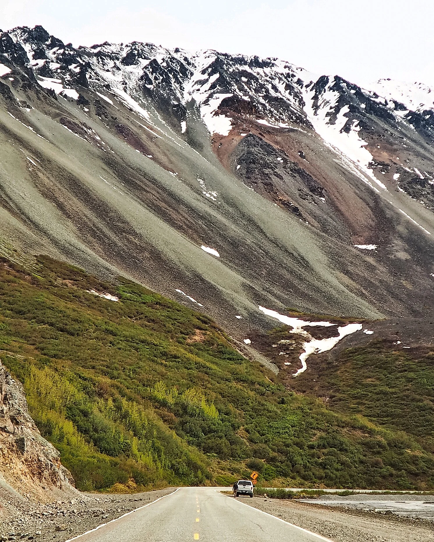 This is Rainbow Ridge Road at Mile 209 on the Alaska Route 2 South. This is one of the hot spots on Alaska Route 2 southbound. It is named "Rainbow Ridge" due to colorful pyroclastic rocks that can be seen on the mountain slope. We were stopping too many times on our way because every spot looked fantastic. Whether you take Route 1, 2, 3, or 8, everywhere along the way is pretty amazing. I always love to stand in the middle of the road to take photos like this. It is dangerous, so if you planned to do so, look behind you every three seconds. Oh and, that's our pickup truck that we are renting for this road trip.