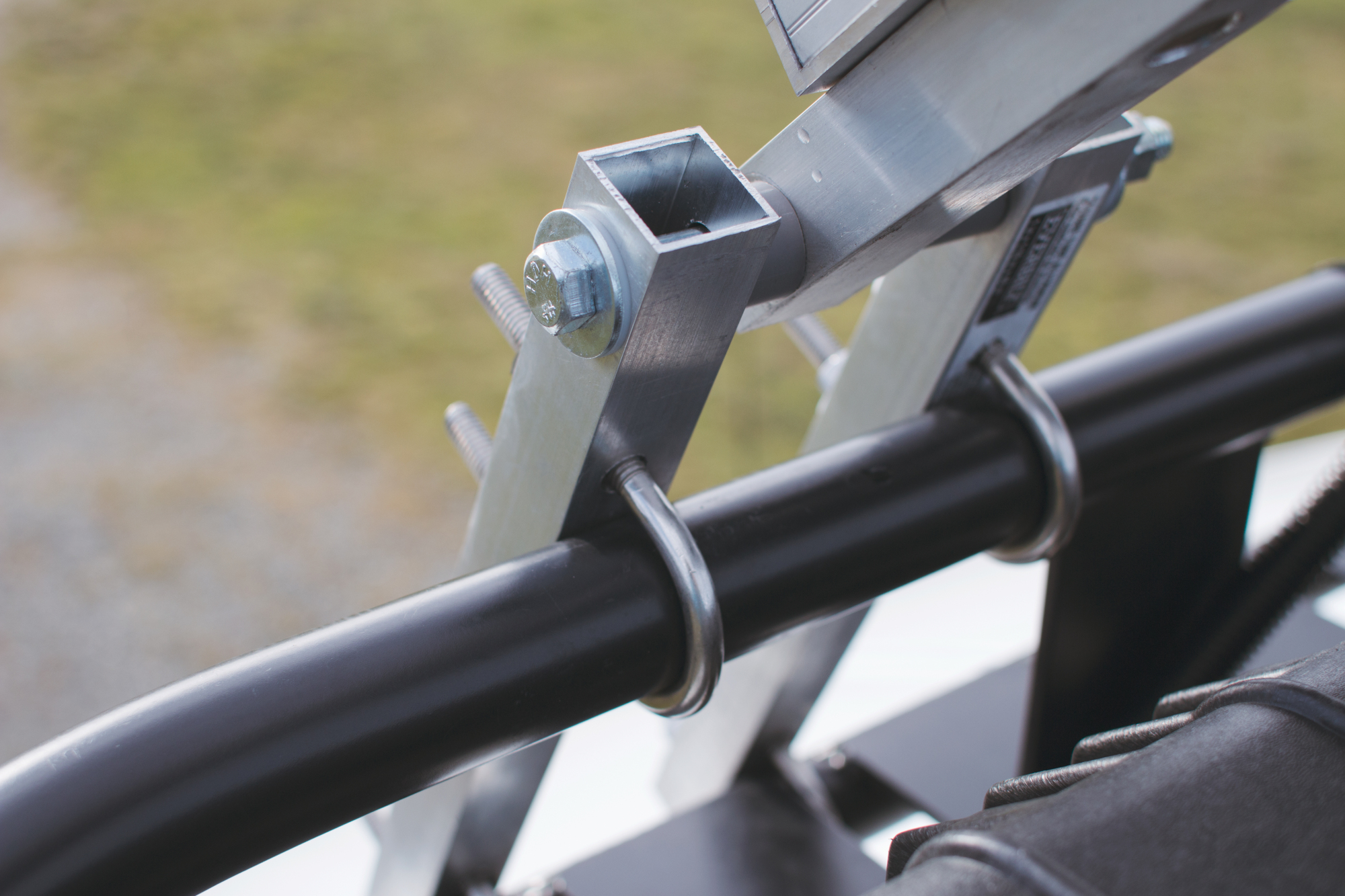 This is the large, custom hinge that Shane created with U-bolts and some steel tubing. The frame for the solar panels came in handy for this part as well.