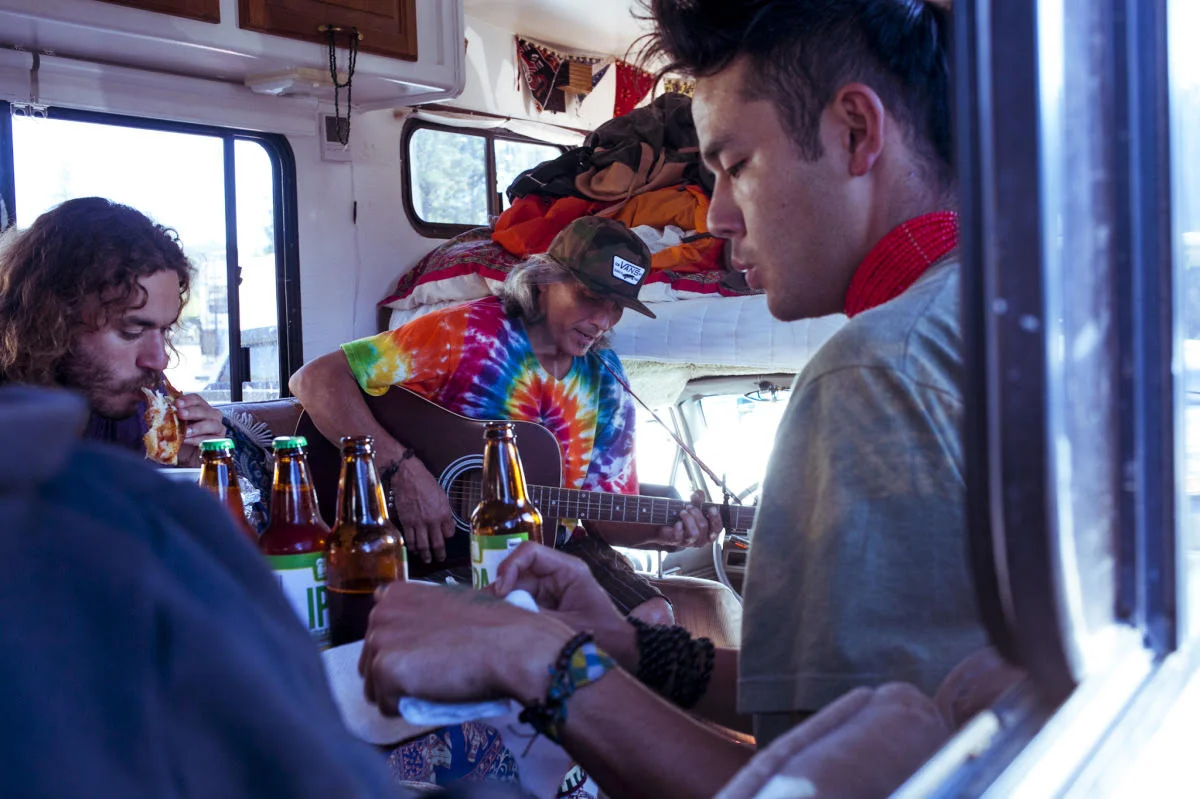 Our road friends Kawika playing guitar, Vasko eating pizza and Sho hanging out in our camper one afternoon. We share our van a lot with other travelers, giving rides and serving food and beers. There was one week where we got caught in a heavy rain and had three friends camping with us. They ended up all sleeping, eating and doing everything in there since it was impossible to step outside.