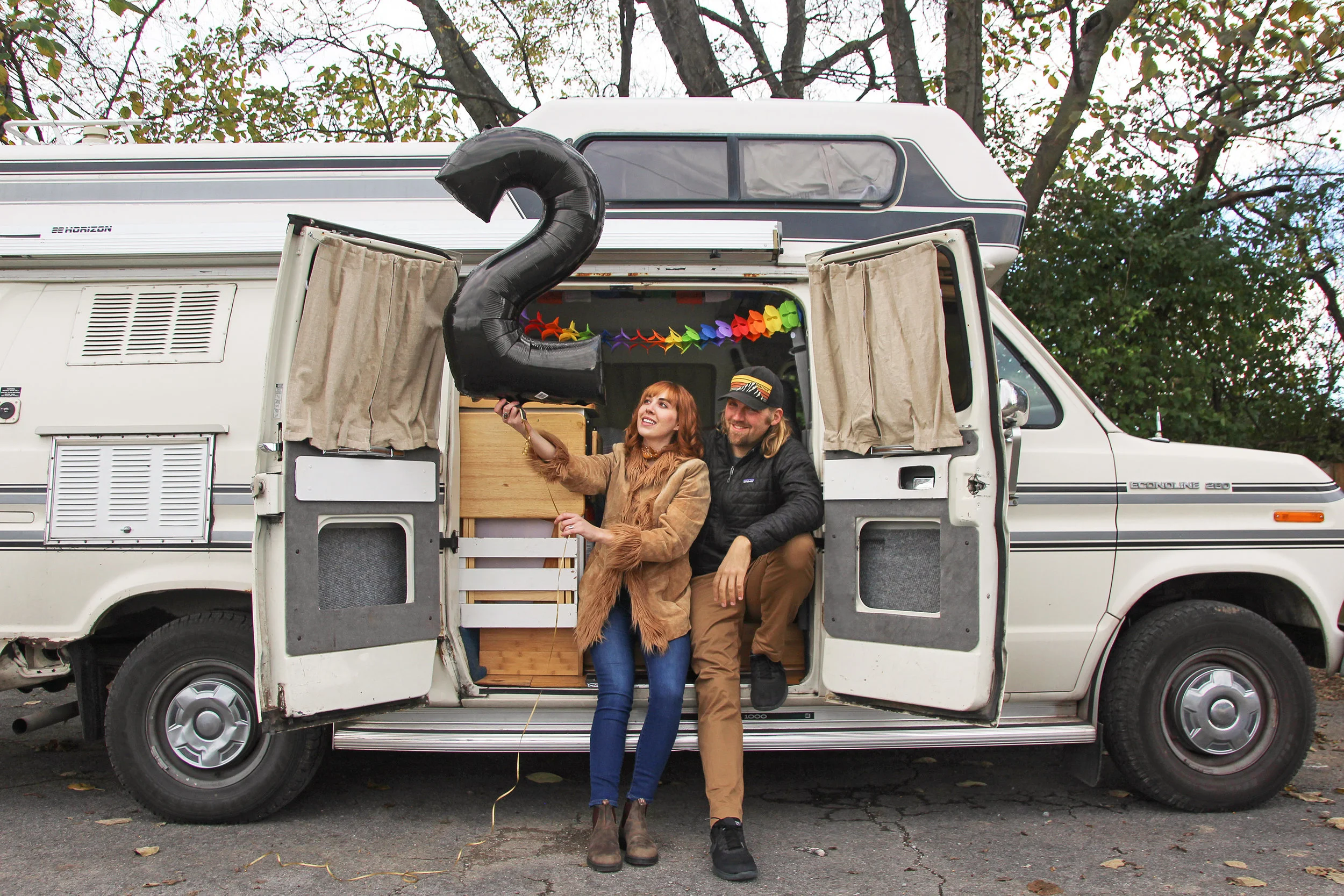 A photo of Savannah & Drew in their rig celebrating two years on the road.