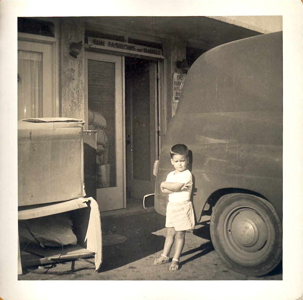 Next to my father's delivery van in his first shop in Kapahulu