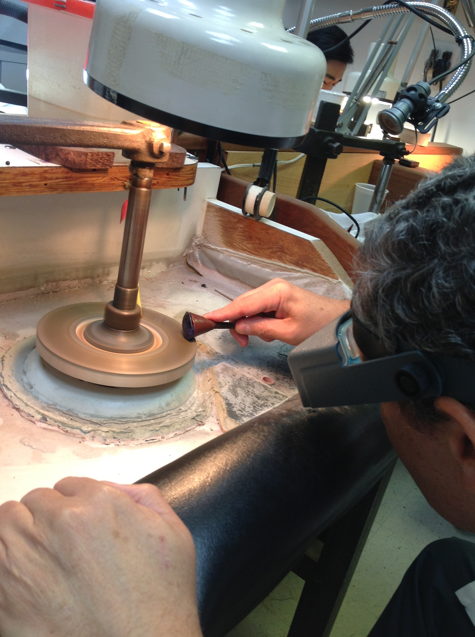 A 120 carat sapphire's girdle is being cut on legendary cutting wheels