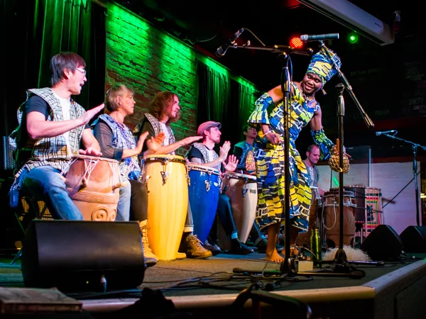Jacky Essombe performs a traditional African dance, accompanied by drums during HOPE International Development Agency fundraising event to benefit children orphaned by AIDS in Ethiopia, held at The Blarney Stone Pub, Vancouver, BC, Canada on November 3, 2013.