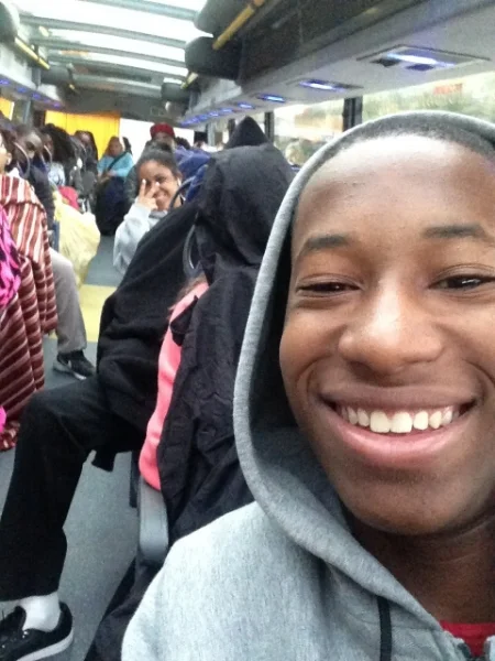 Korey photobombed by a smiling Angeliz and a sleeping Anthony