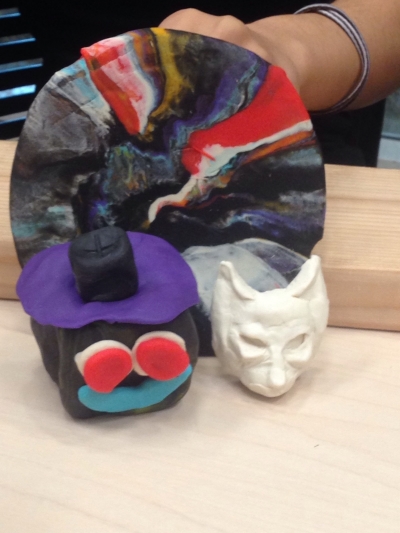 Here's a picture of Rochely's hand holding up Play-doh sculptures. The colors represent different values that one must uphold as members of the North Philadelphia Youth Advisory Council. Rochely's sculpture is the fore fronting, cube-shaped face. To Rochely, respect (represented by the color black), is the most important quality to exchange with one another as a successful Council.