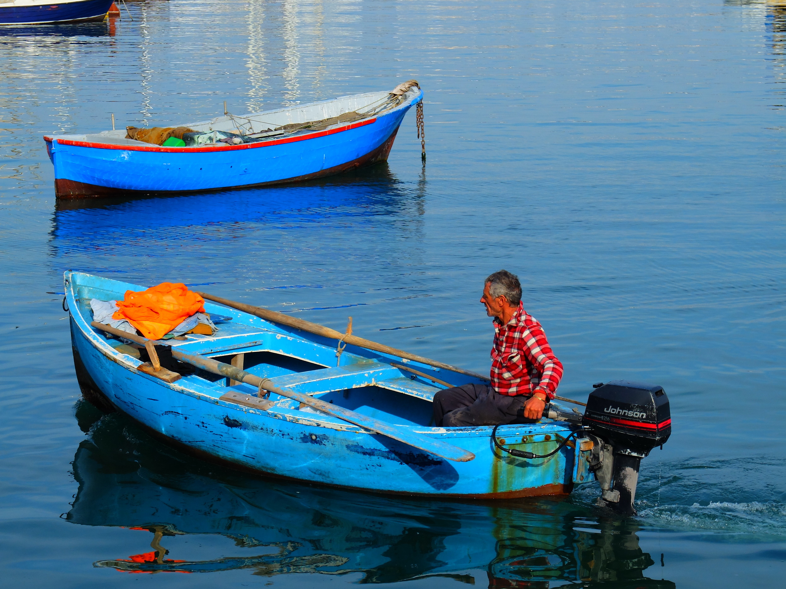 Fisherman on placid waters, Bari, Italy
