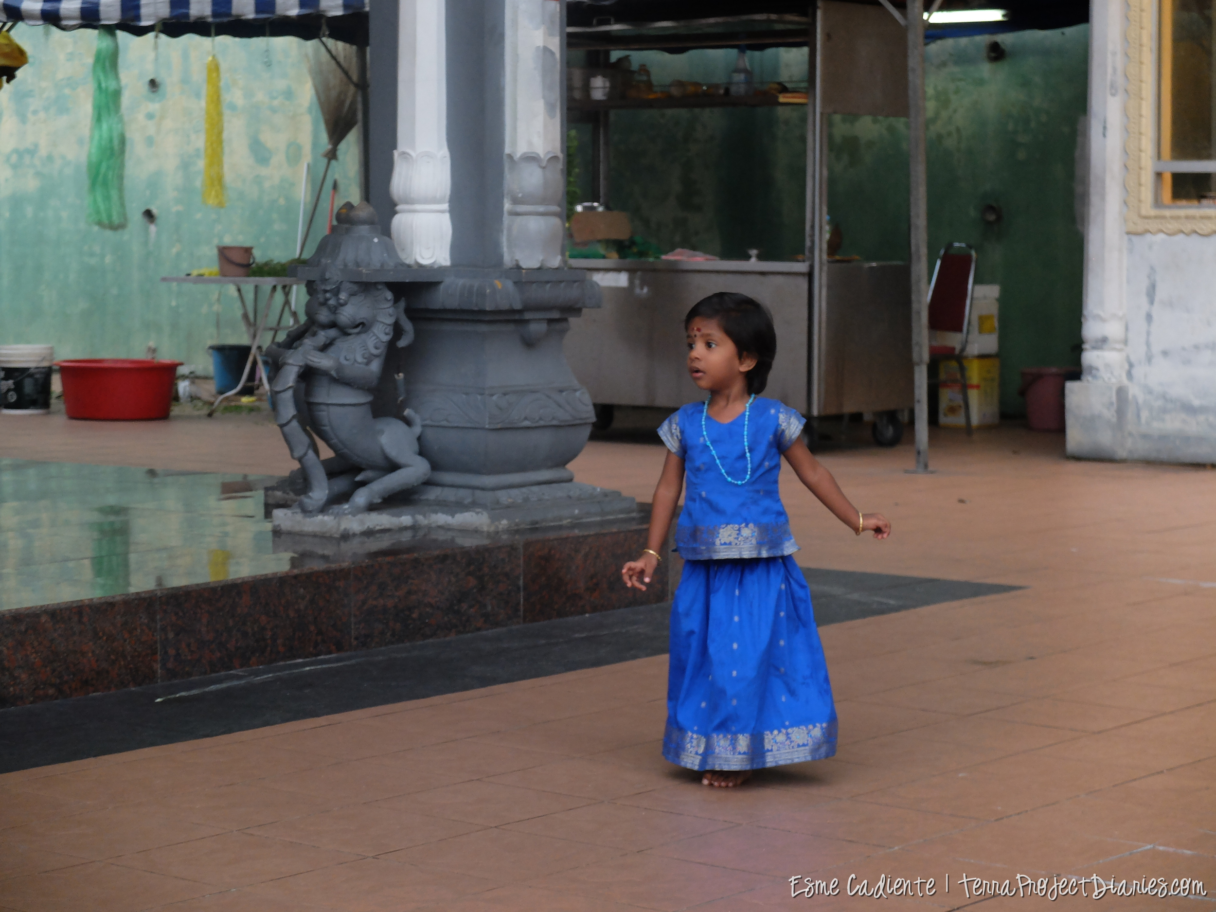 An Indian child runs around an Indian temple