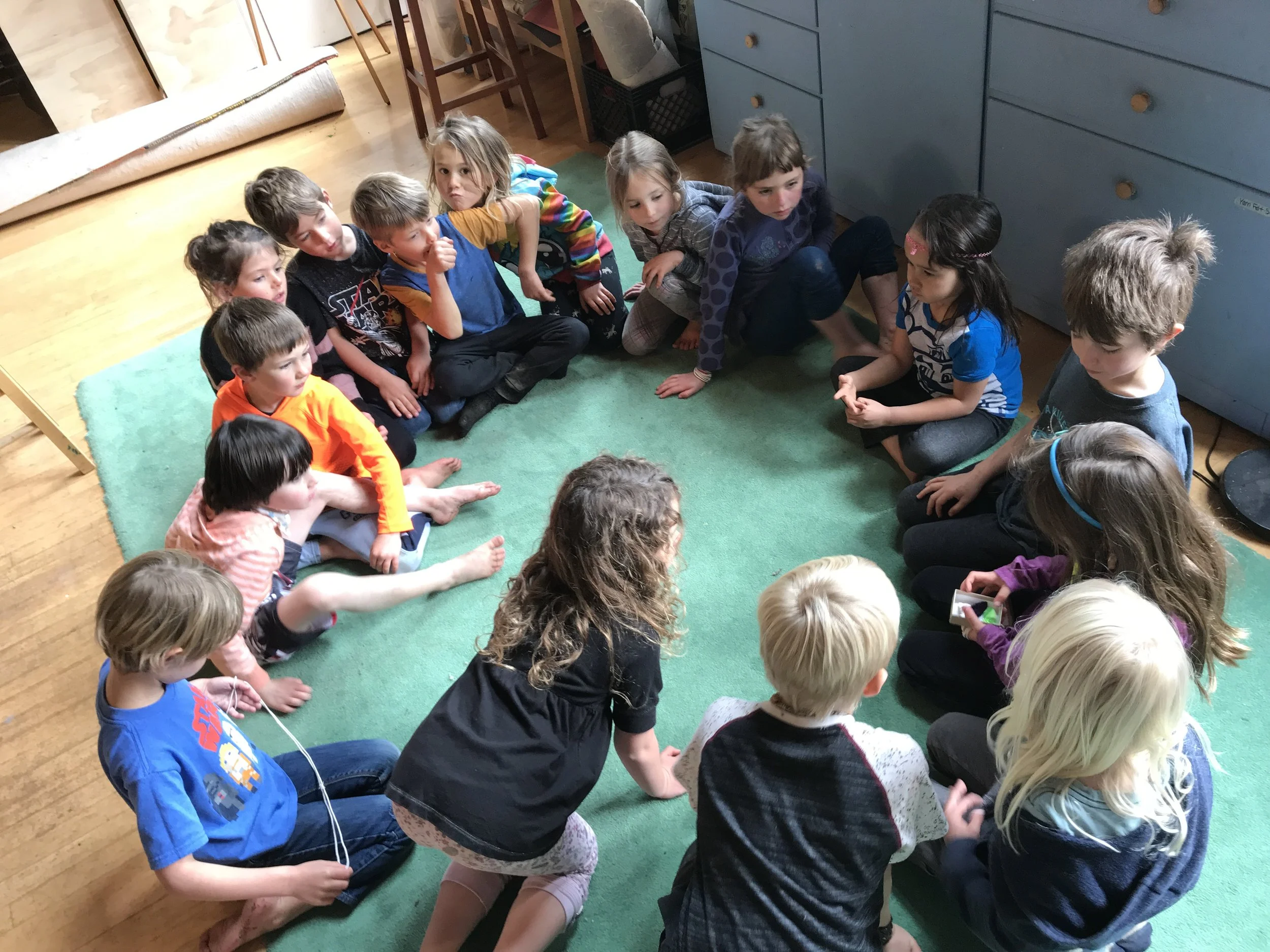 I asked the class to go find a spot on the green rug.....and they formed this tight, little circle of darlingness and magic.&nbsp;