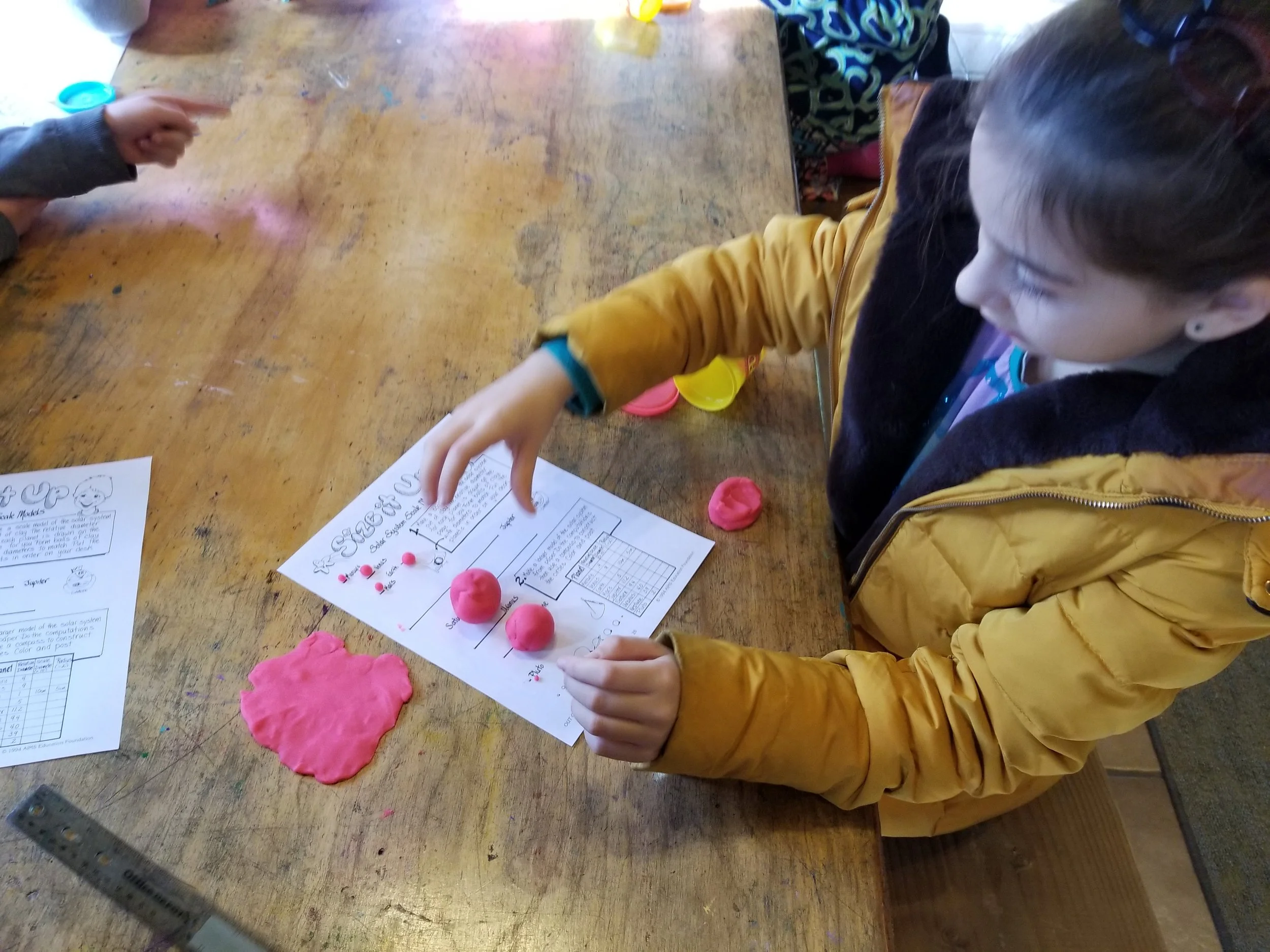 Making clay planetary models.