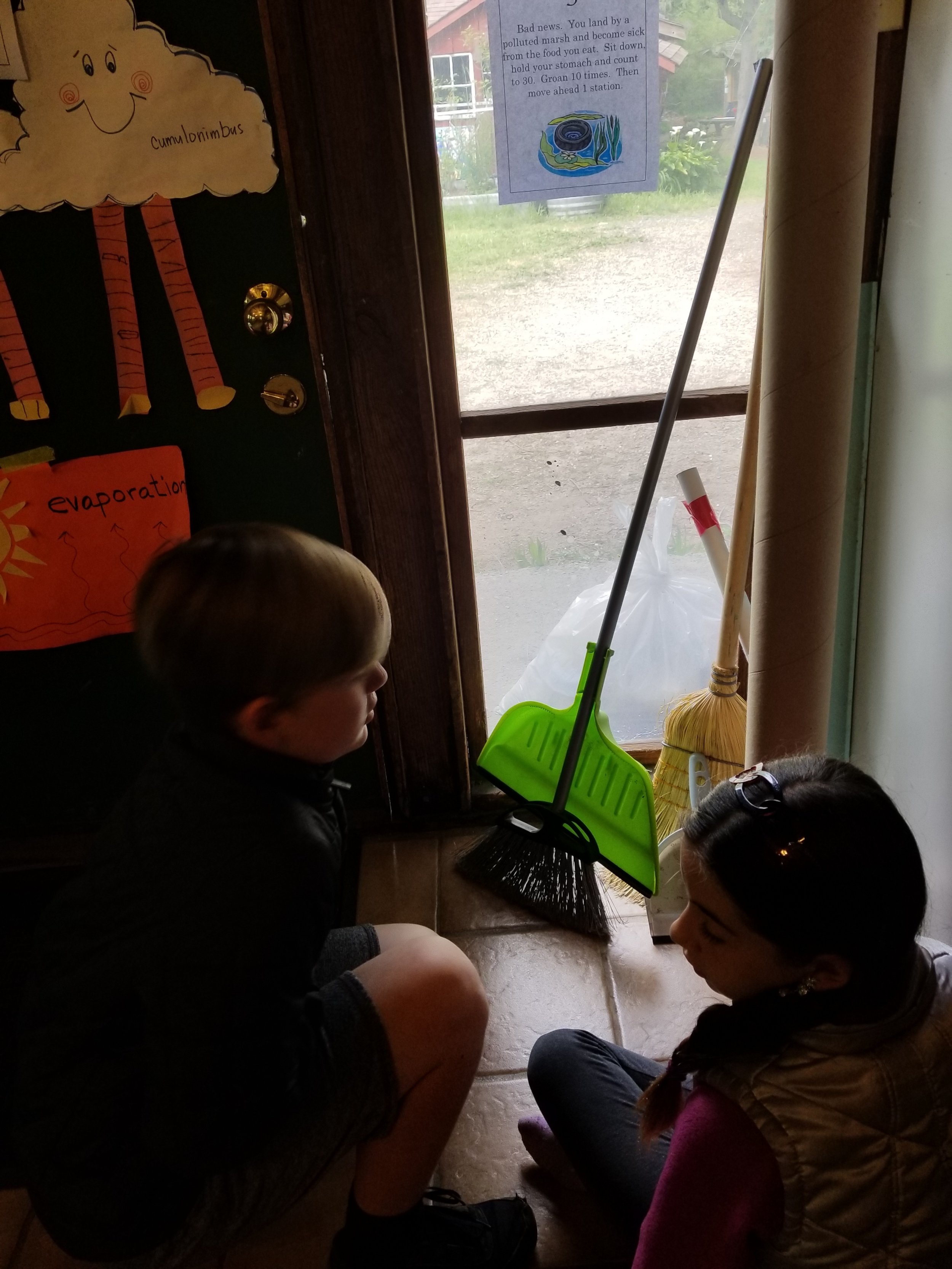 Jaxson and Nia read one of the first game board spots of the migratory bird game.&nbsp;