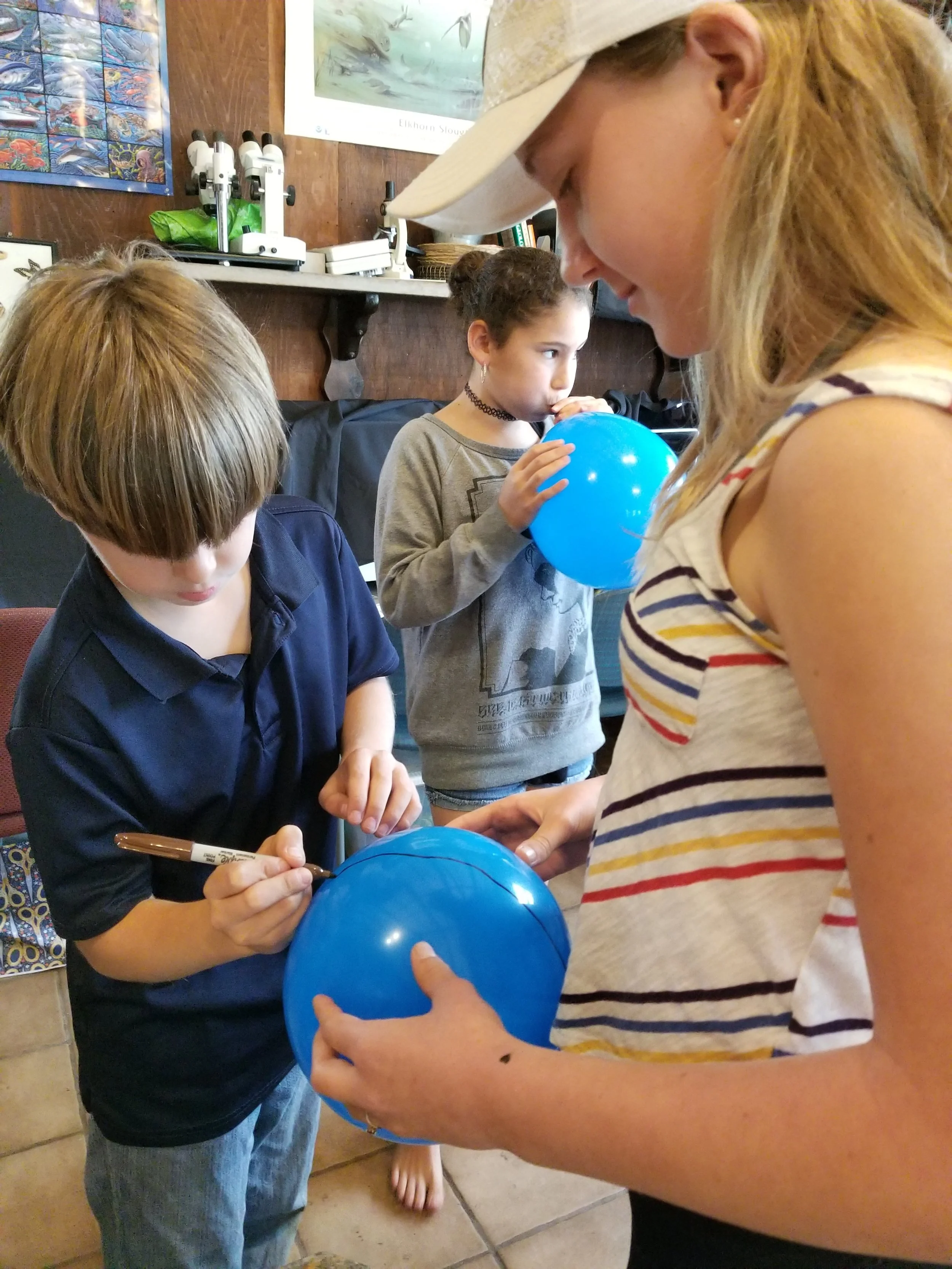 Drawing the equator on the earth models.&nbsp;