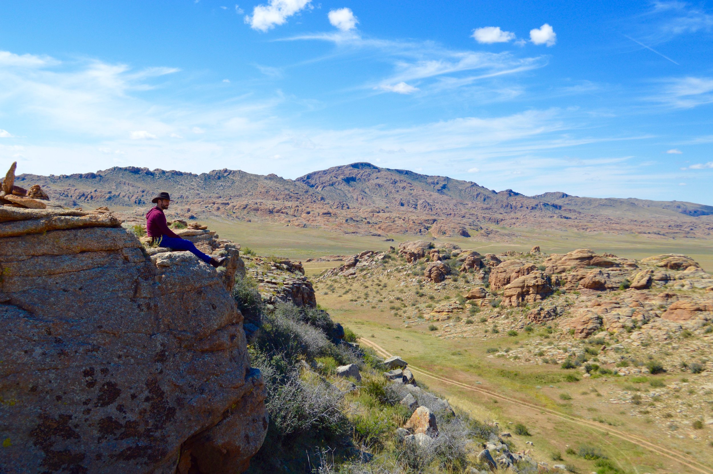 Art sits on the edge of a cliff surrounding a monastery