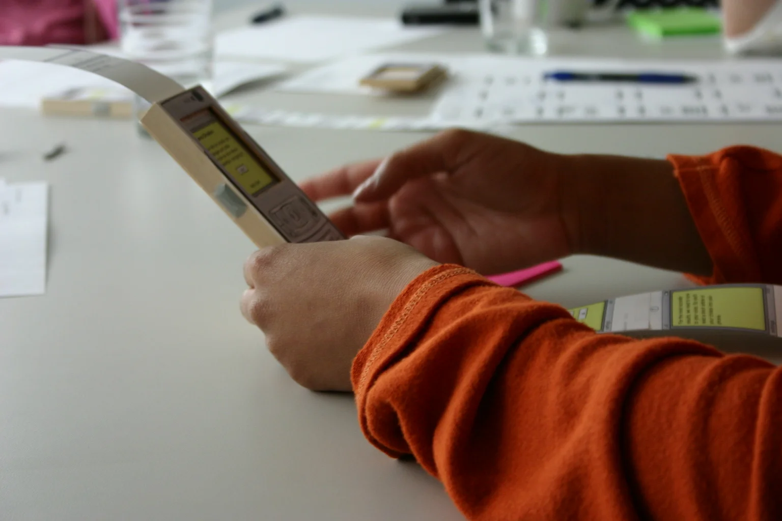 Wood-block phone with embedded earbud speakers and and paper-scroll UI (pre InVision and iPhone)