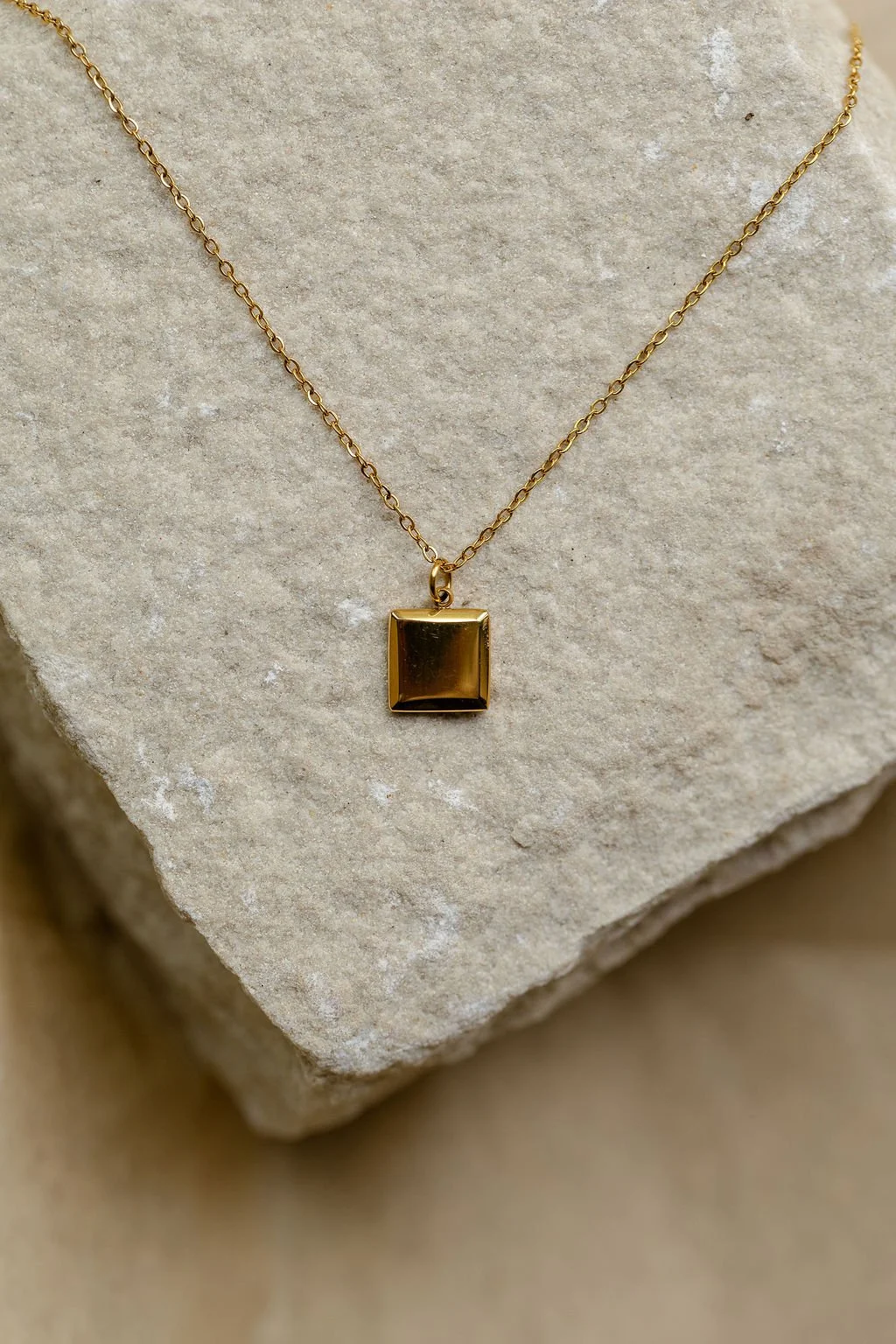 square-frame-necklace-on-stone.jpg