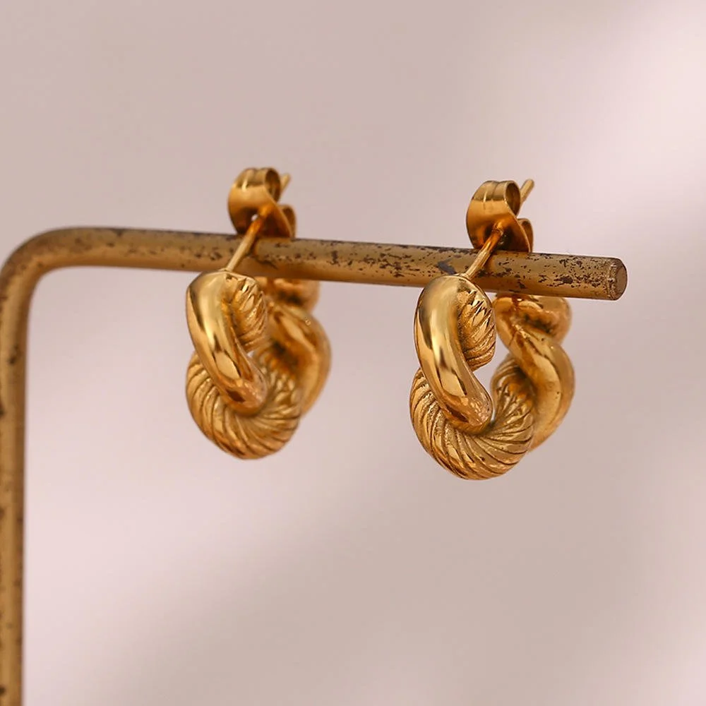 House Thirteen Twisted Knot Hoop Earrings displayed on gold earring stand, tarnish resistant twisted knot gold hoops