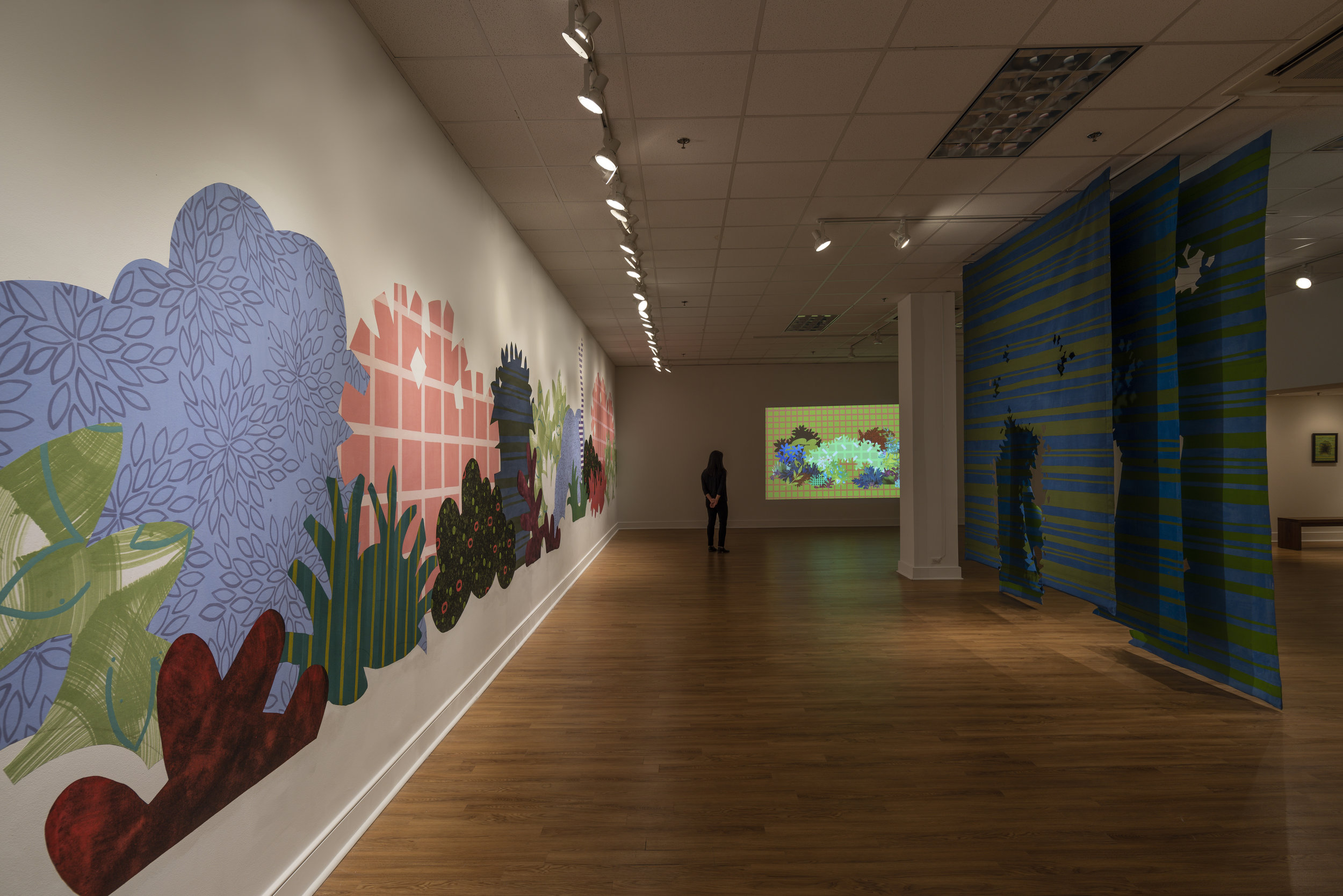  Works from right to left:     Proscenium Hedgerow   (2018) 11ft x 10ft x 2ft; series of three latex on cut muslin panels    Blinky Bricolage   (2019) 3 minute animation on loop, projection; collaboration with Kyle Statham     Piecemeal Promenade   (