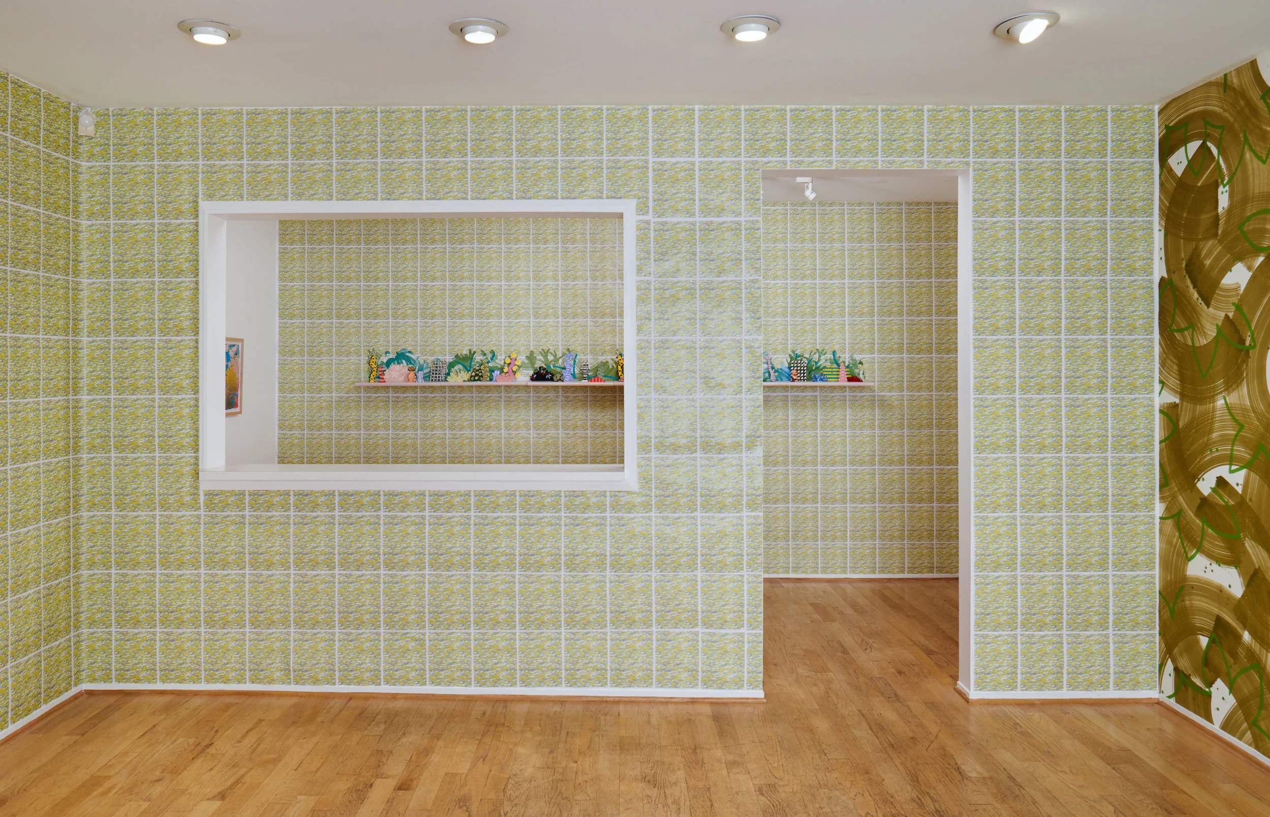 works from left to right: Horizon Allsorts , (2018) Six floating wood shelves, painted muslin, ceramic, underglaze and glaze; 12ft x 1ft x 9inches Sloppy Espalier , (2018) detail; Painted muslin wall covering, painted and cut muslin garland, wood blocks, painted magnets; 22ft x 9ft This installation includes wall paper by Devon Tsuno