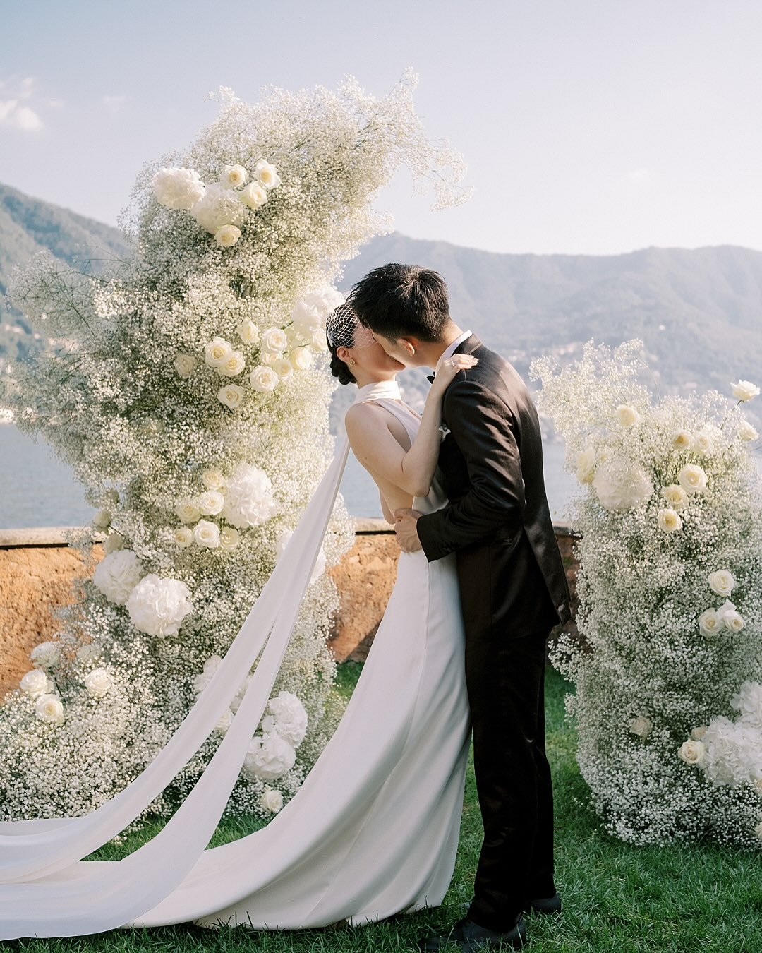 Another set of Kathy &amp; Kyle on Lake Como.

It&rsquo;s one of those long summer days &mdash; full of enchanting ambiance, giggles, lushness, and a stunning backdrop.

Outdoor wedding ceremony in the garden of Villa Regina Teodolinda, with a panora
