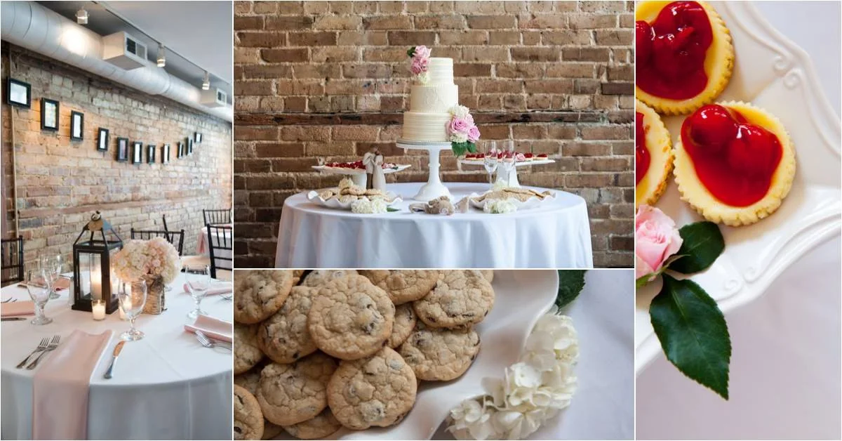 Decorated tables with a wedding cake, chocolate chip cookies, and cherry-topped cheesecakes at a celebration event in a brick-walled venue.