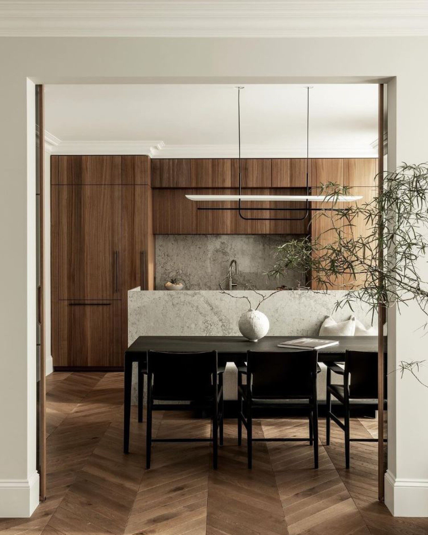 &quot;Ample natural light floods the space, highlighting the minimalist details and creating a warm and welcoming ambience. The dining area, seamlessly integrated into the kitchen, features a simple yet stylish table surrounded by elegant, comfortabl