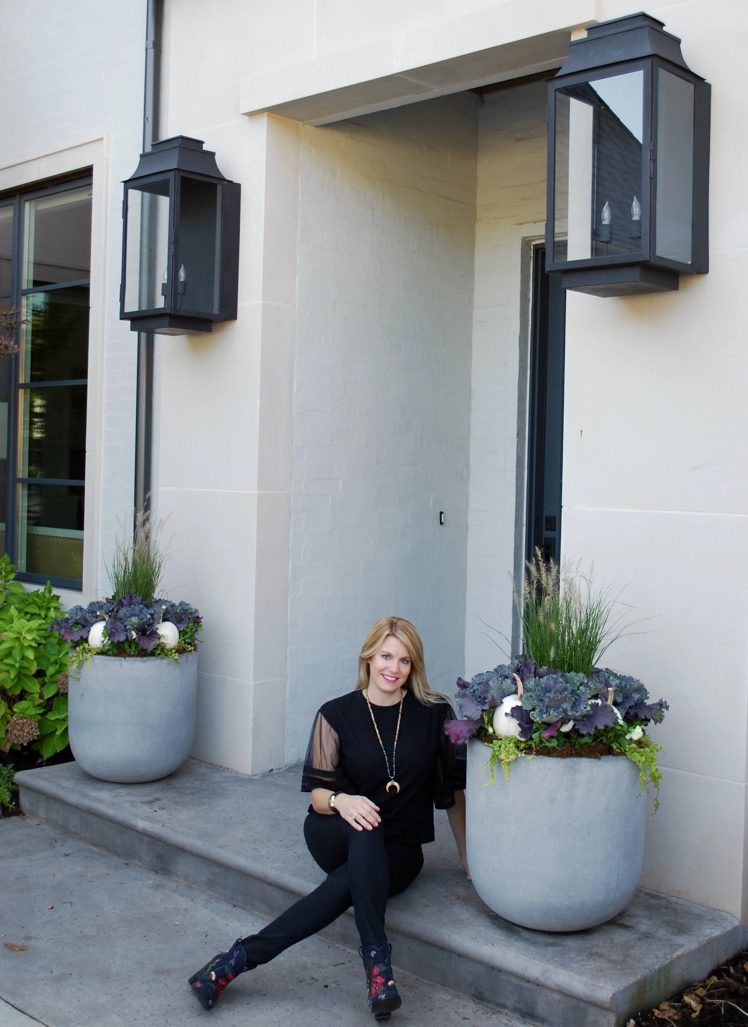 Curb Appeal Shout Out! Imagine our delight when we got the call last April from Kristine Bates, an incredible interior designer in OKC, to lend her a hand with her outdoor planters. Her amazing home was going to be on the Nichols Hills Garden Tour and her outdoor pots needed a fresh new look for the summer season. Kristine loves what outdoor planters can add to a back patio. "Outdoor pots, especially when they are professionally done, can add so much to an outdoor living space. Our covered back patio is an extension of our home and our family spends time there daily. All our living room and kitchen windows look out onto our back patio so we really need our outdoor planters to look fantastic. As a designer, it's important for our house to look "finished" on the inside and out. It's nice to be able to outsource the container gardens to Adorn because I know they will look wonderful all season long. Elizabeth has helped with our planters now for two seasons - summer and fall. I highly recommend her to my clients too." We LOVE digging in the dirt at her beautiful home! Kristine's firm, Kristine Bates Interiors, does everything from updating to designing complete house plans starting from the ground up to final completion. She is SO talented and we are thankful for the opportunity to work with her and her team on a seasonal basis.