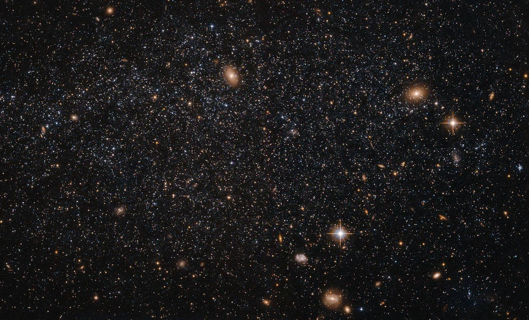 This spattering of stars, believe it or not, is the irregular galaxy Leo A. The really bright objects are actually other galaxies in the background or stars in OUR galaxy that are "in the way." Photo: NASA/ESA/Judy Schmidt