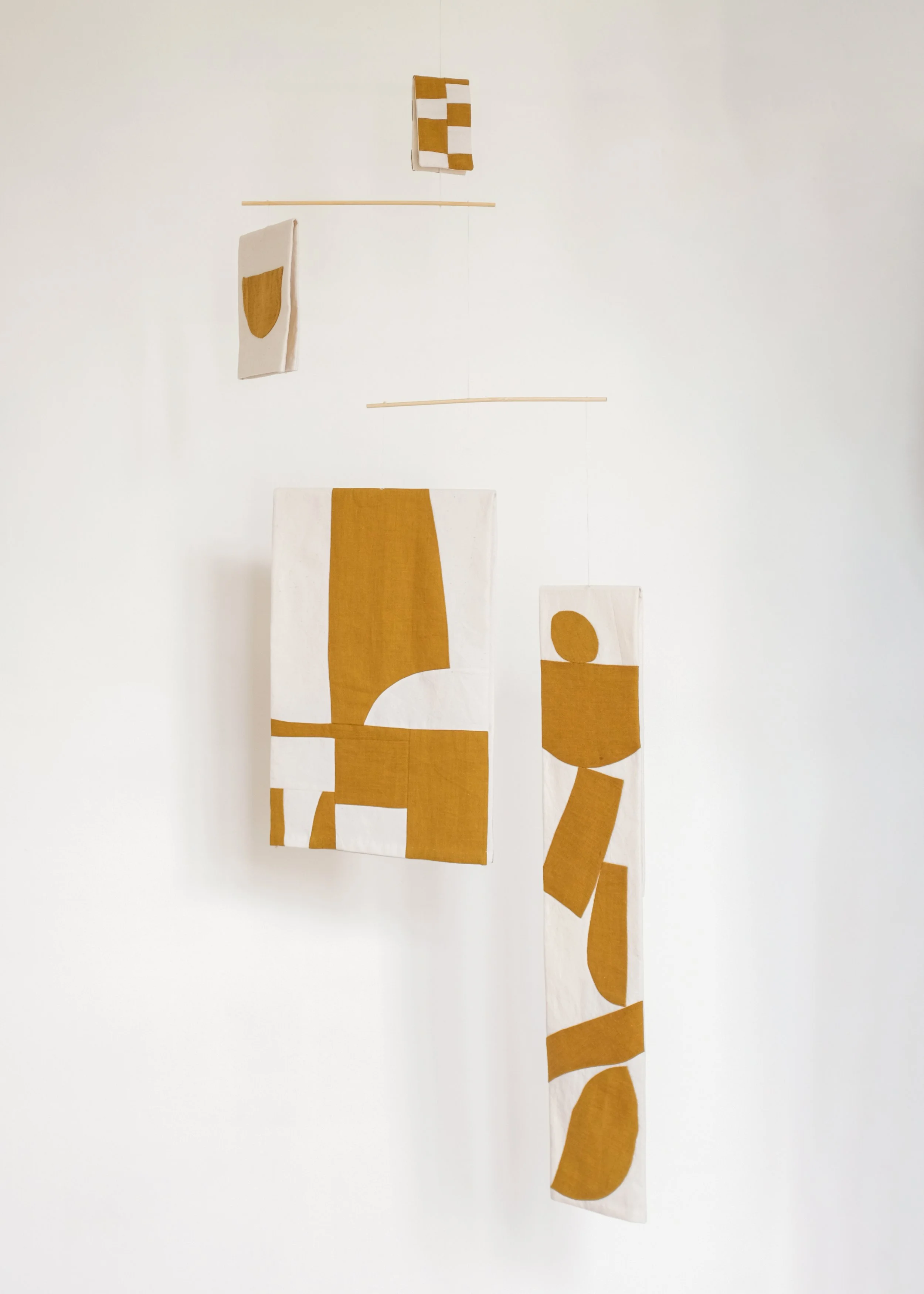 Kinetic sculpture or mobile by House of Quinn made from fabrics and textiles which have been hand stitched together