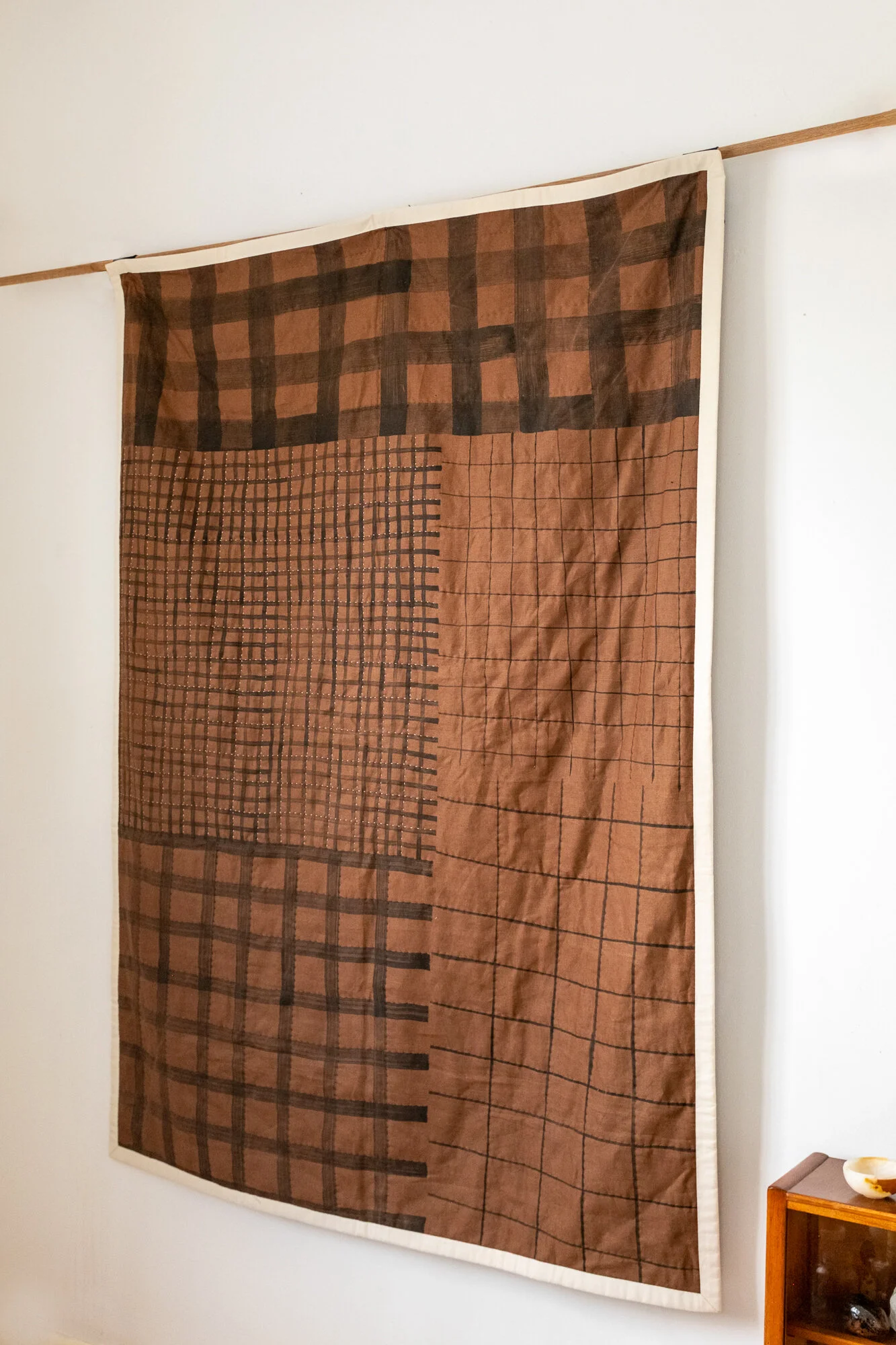 Hand painted, check quilts by House of Quinn featuring abstract check patterns across the surface of the linen.