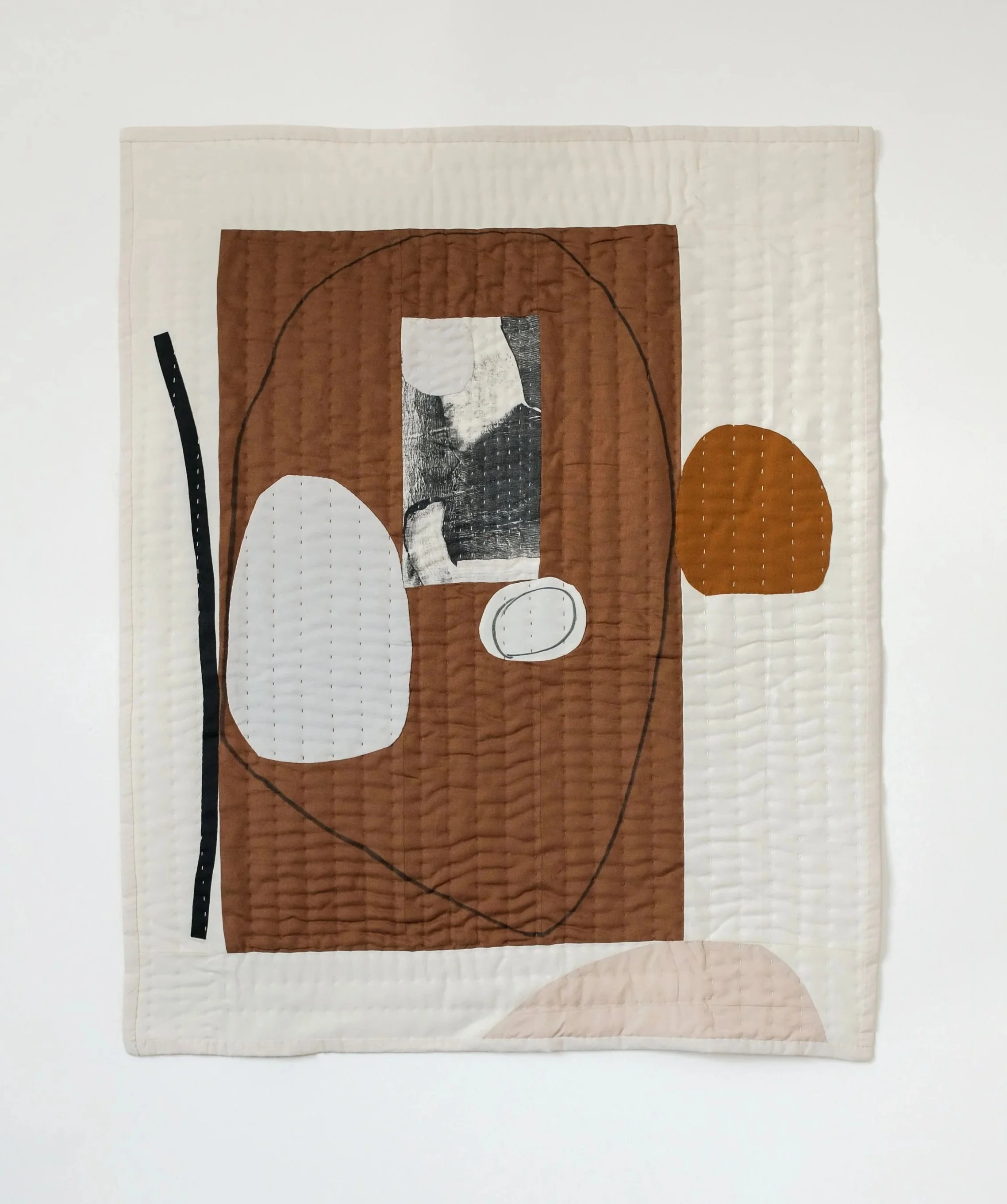 Abstract, modern quilt by House of Quinn.  Featuring stone like shapes in and mono printed fabrics.