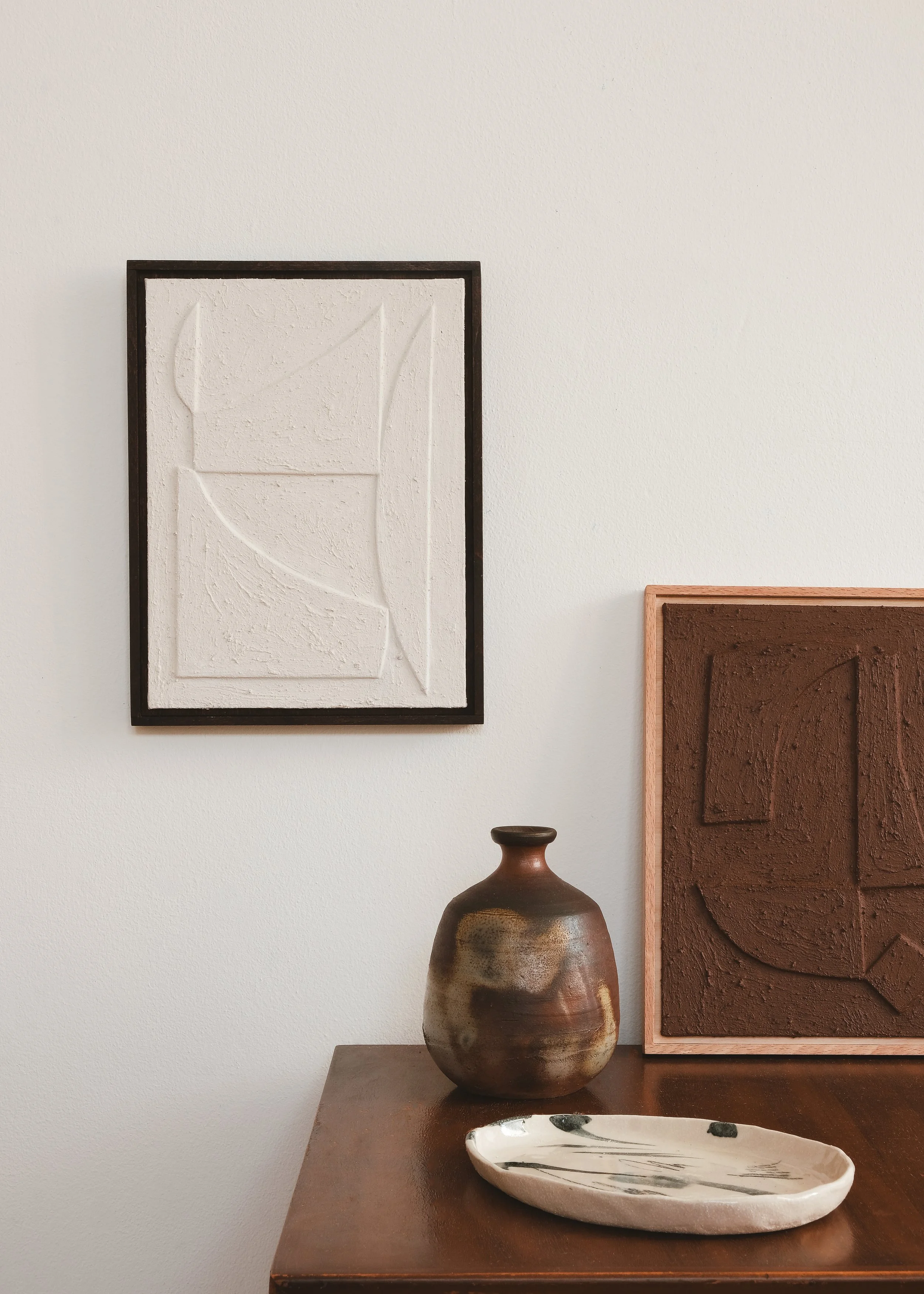 Caer relief painting by House of Quinn in Chalk White. A textural, abstract painting featuring contemporary forms and shapes. Styled in an interior setting. Minimalist artworks