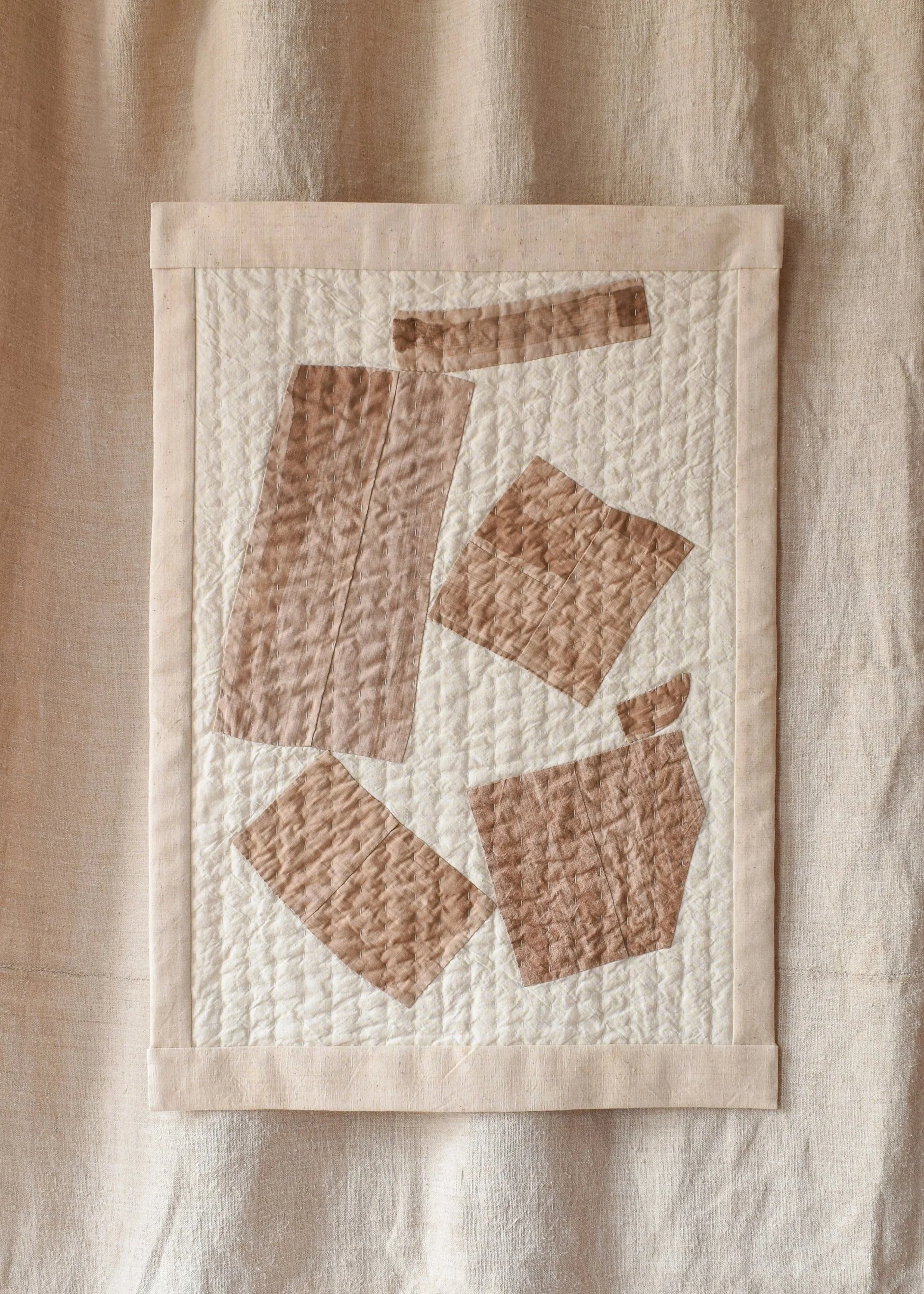 Abstract, quilted artwork made from antique cloth and abstract forms. Each form has been tea dyed by House of Quinn.
