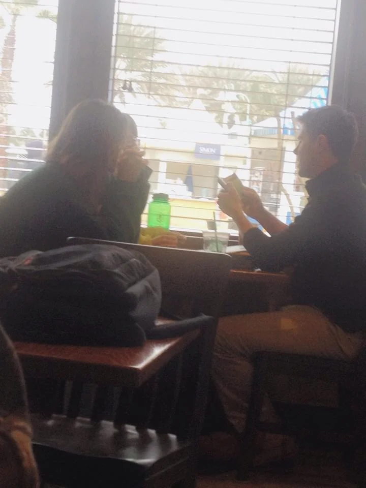 Two of our students sharing the Gospel (via the "Knowing God Personally" booklet) with a man they met in a coffee shop during our spring break trip to Panama City Beach.