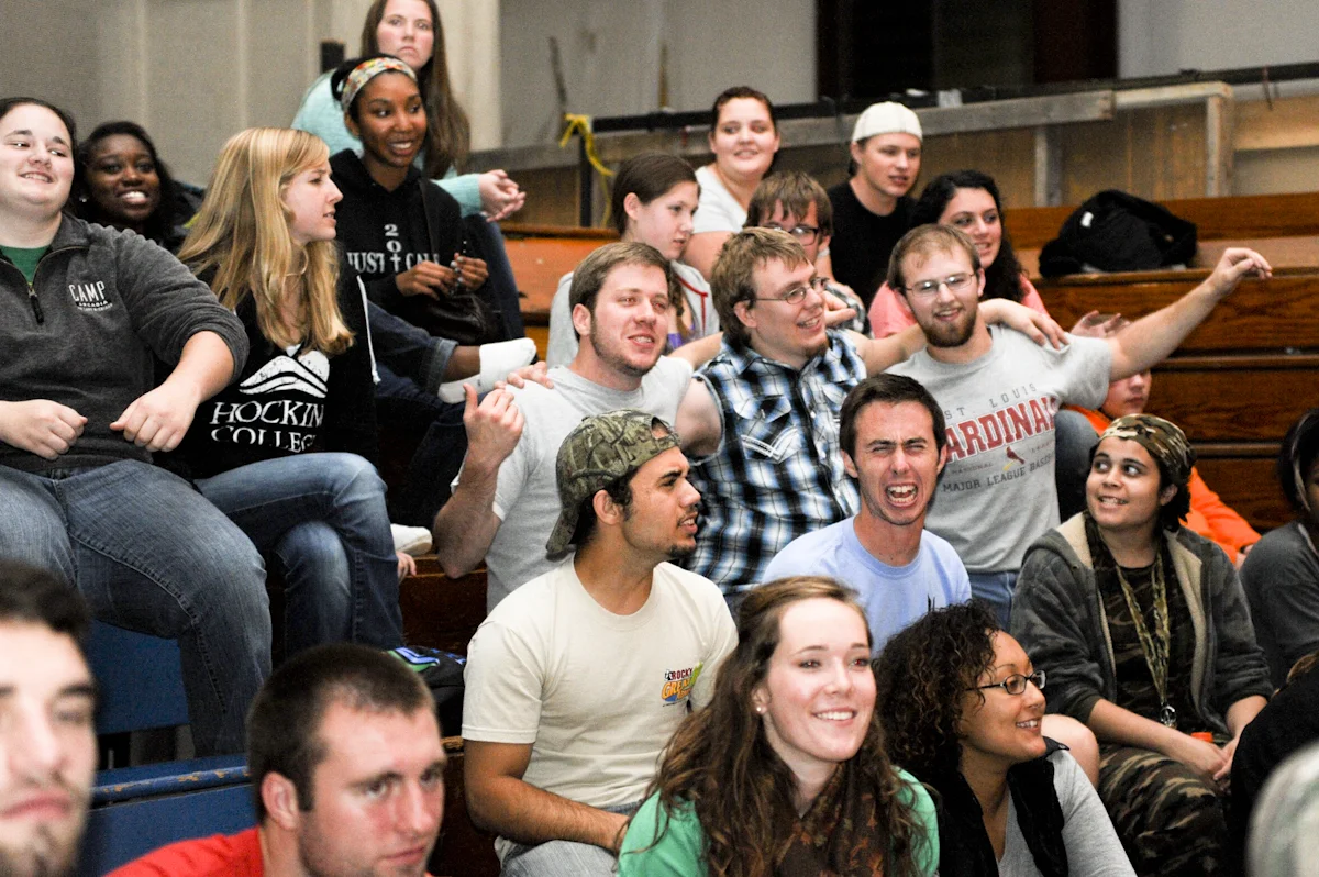 Clay enjoys a laugh with some of his disciples (students he mentors) during a song at Fall Retreat.