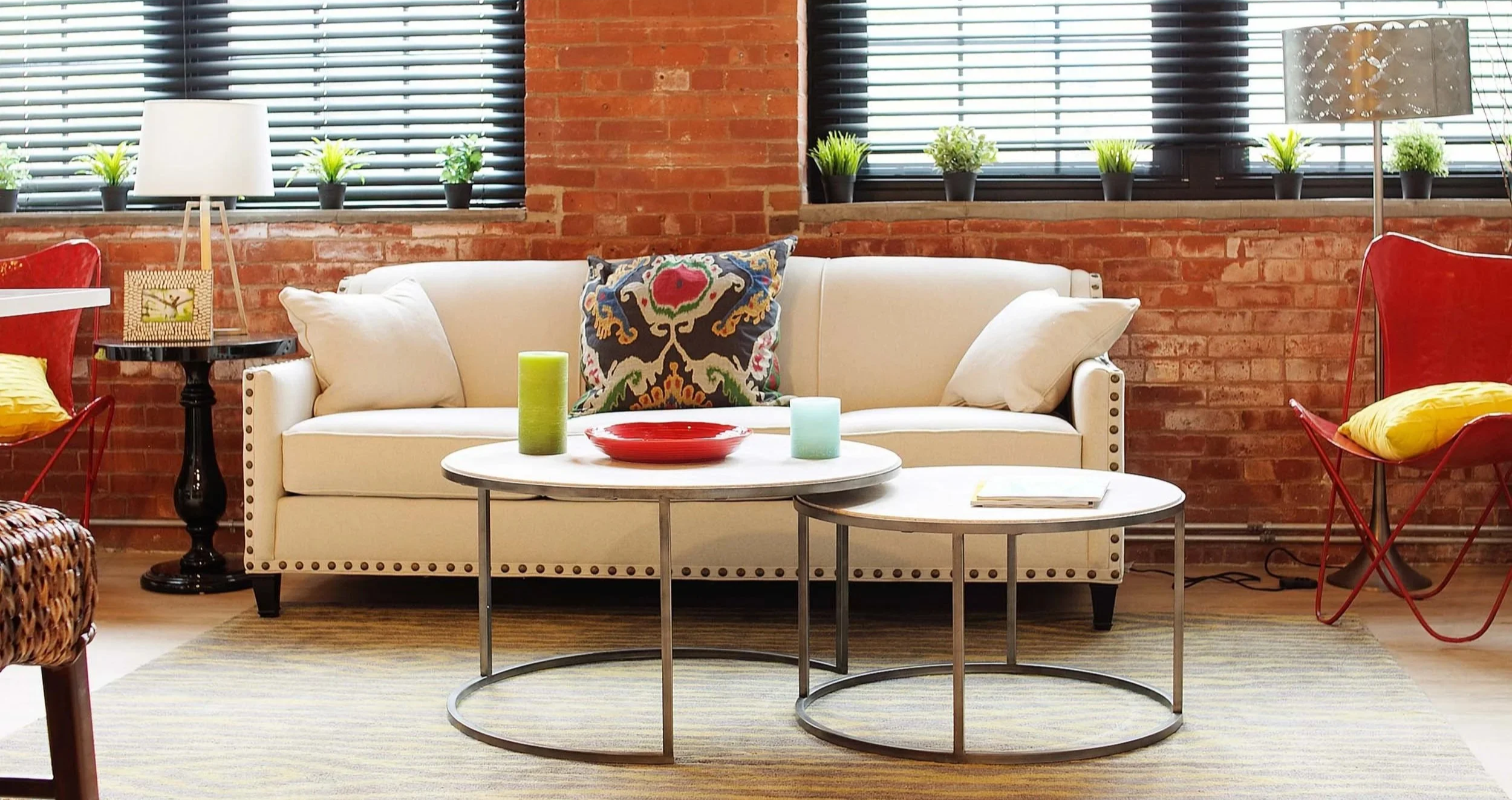 Light-filled residential interior with exposed brick, white sofa, and modern furnishings, photographed for property marketing in Connecticut