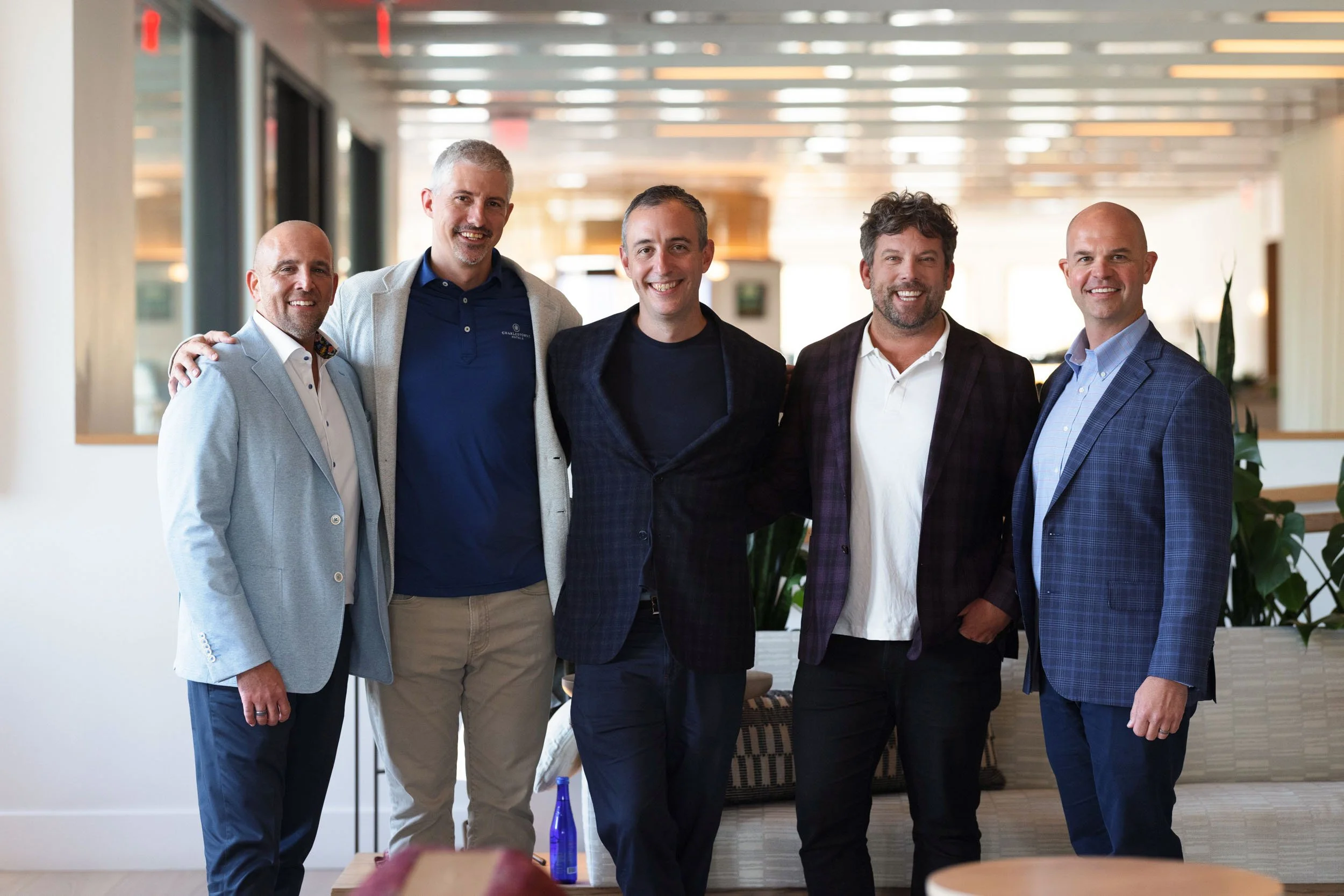 a corporate group shot of five men in the lobby of Hotel Marcel 