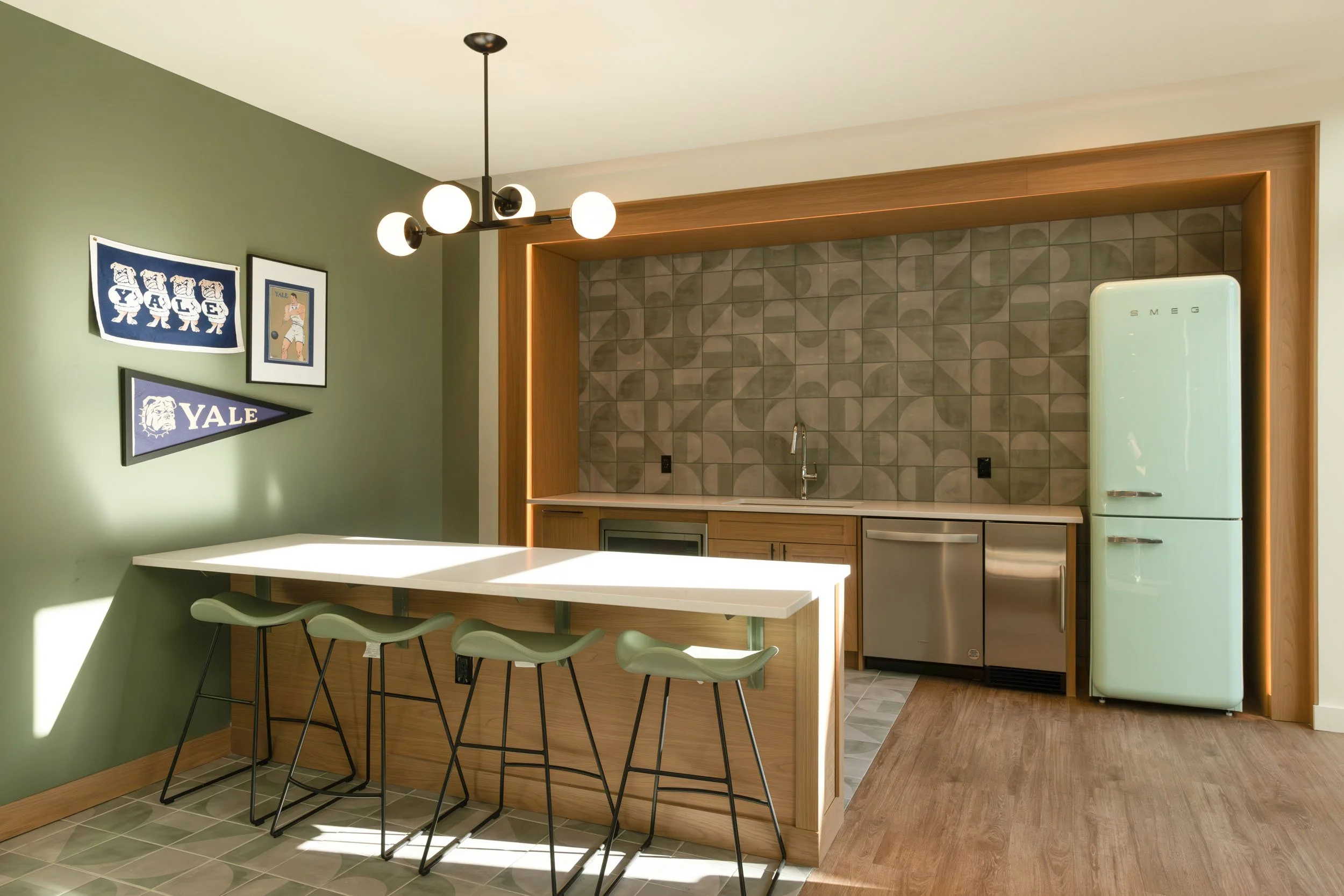 Modern residential kitchen with island seating, custom cabinetry, and natural light photographed in New Haven