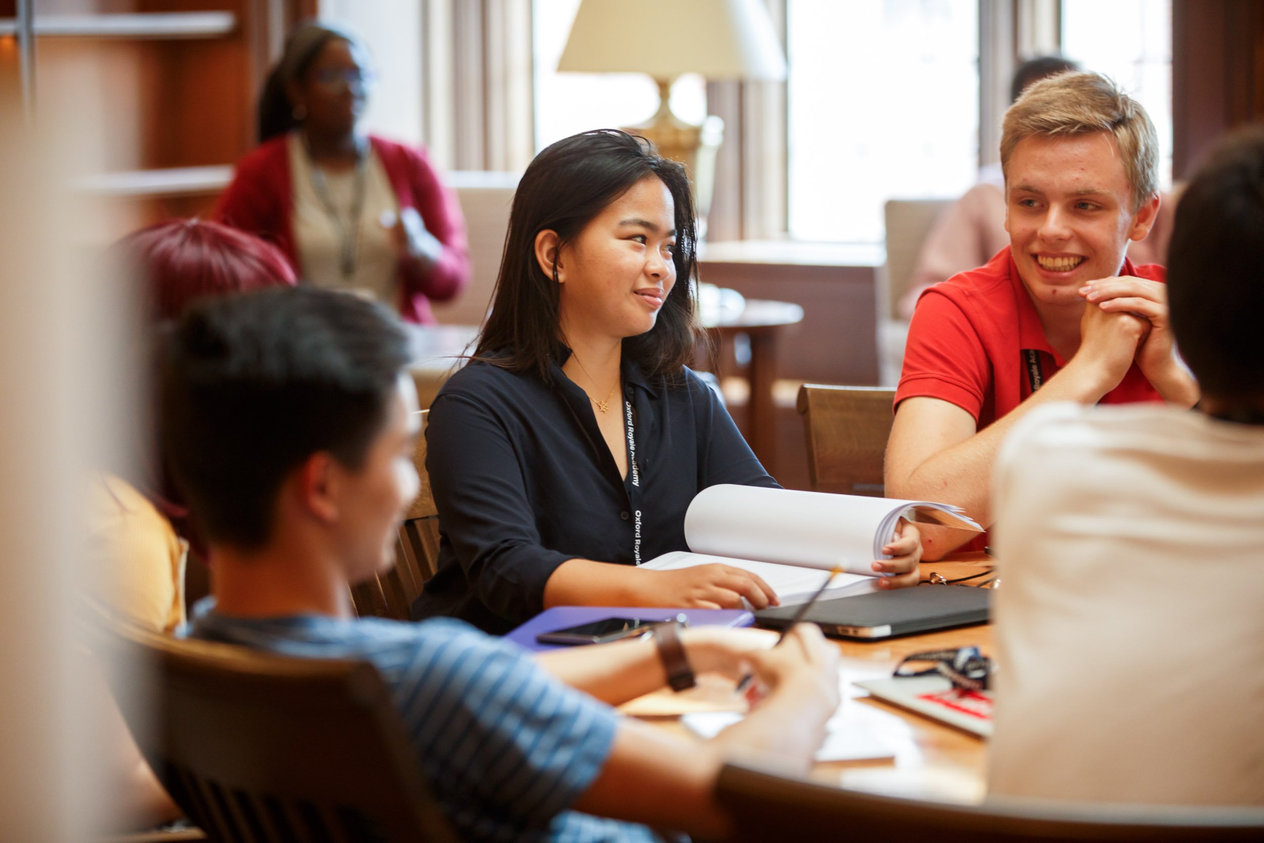Students at Yale at a table and talking