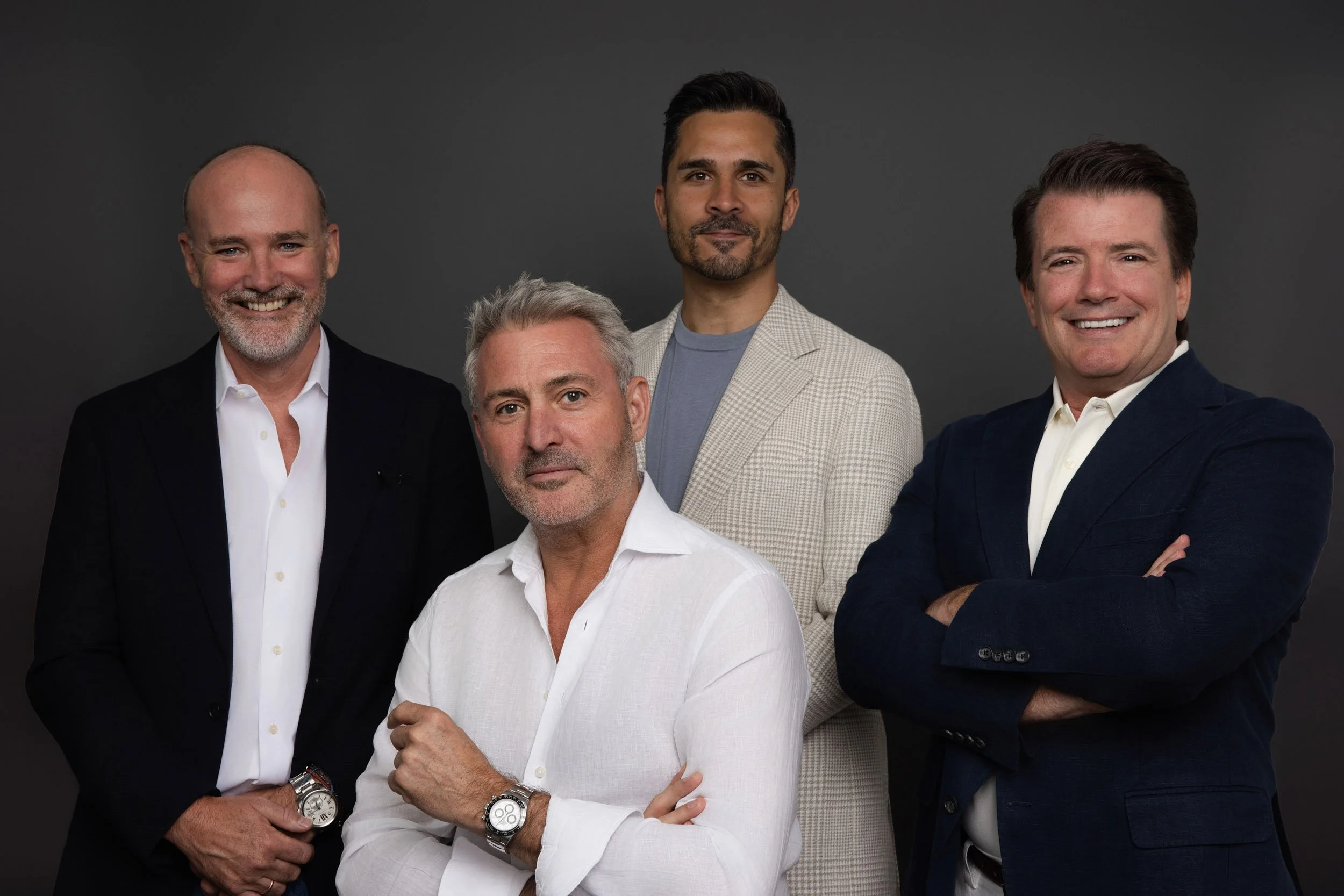 Executive team portrait agains a dark background