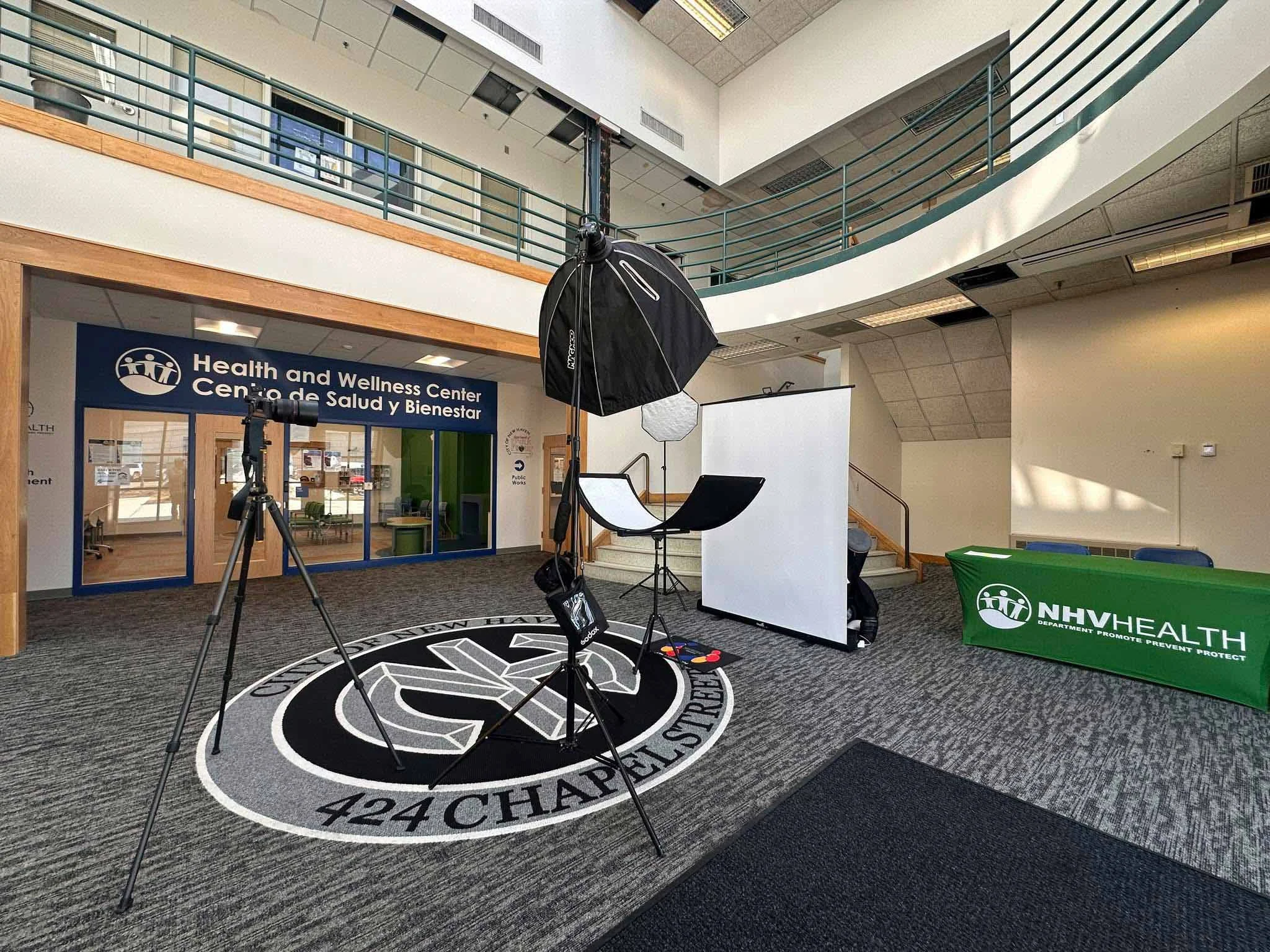Professional on-location corporate headshot setup with lighting and a white backdrop in New Haven, Connecticut.