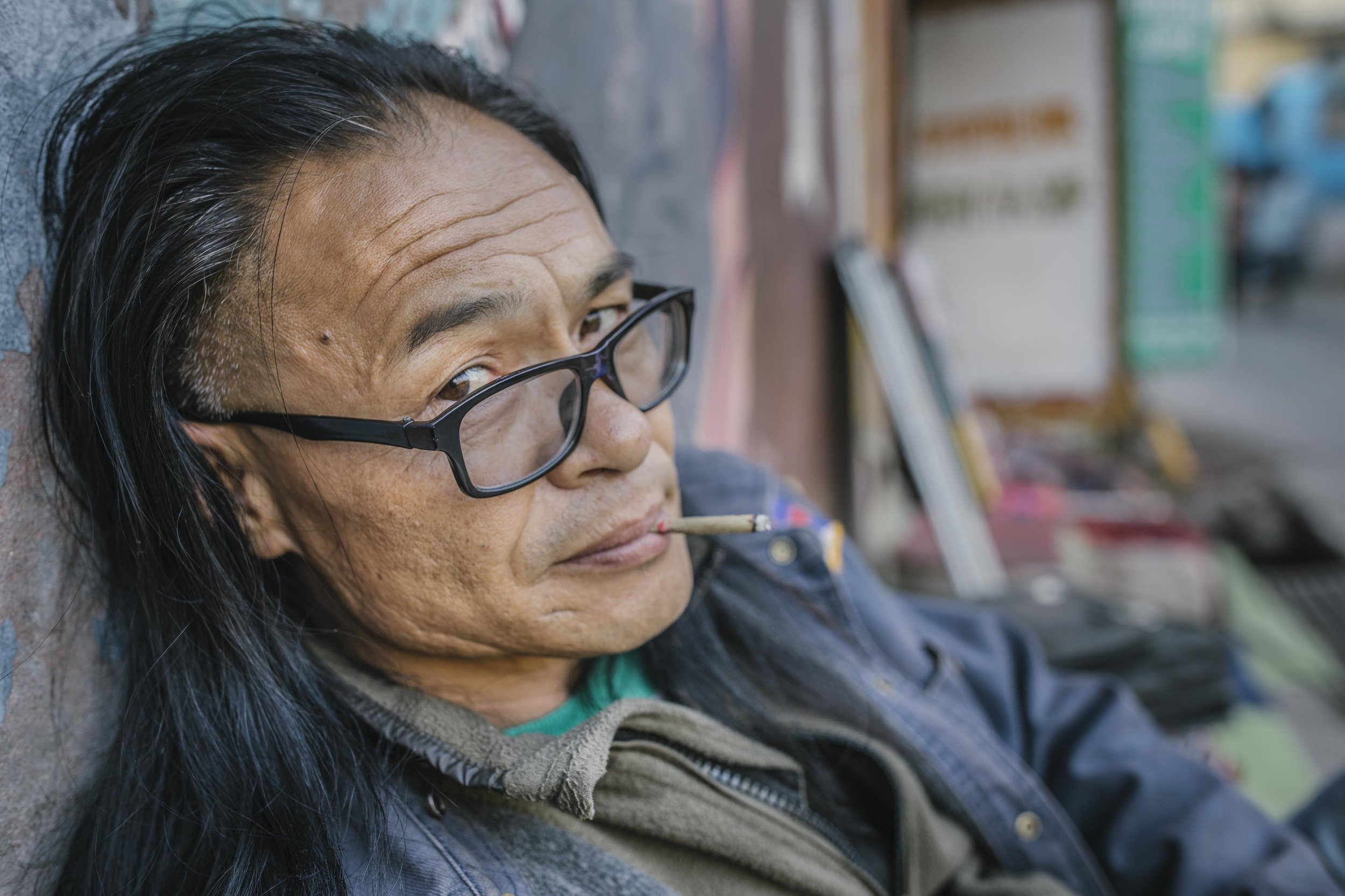 Mesib Norbu, former monk, writer and part of Free Tibet movement outside the poetry tea shop he runs in Mcleod Ganj, Himachal Pradesh, India.