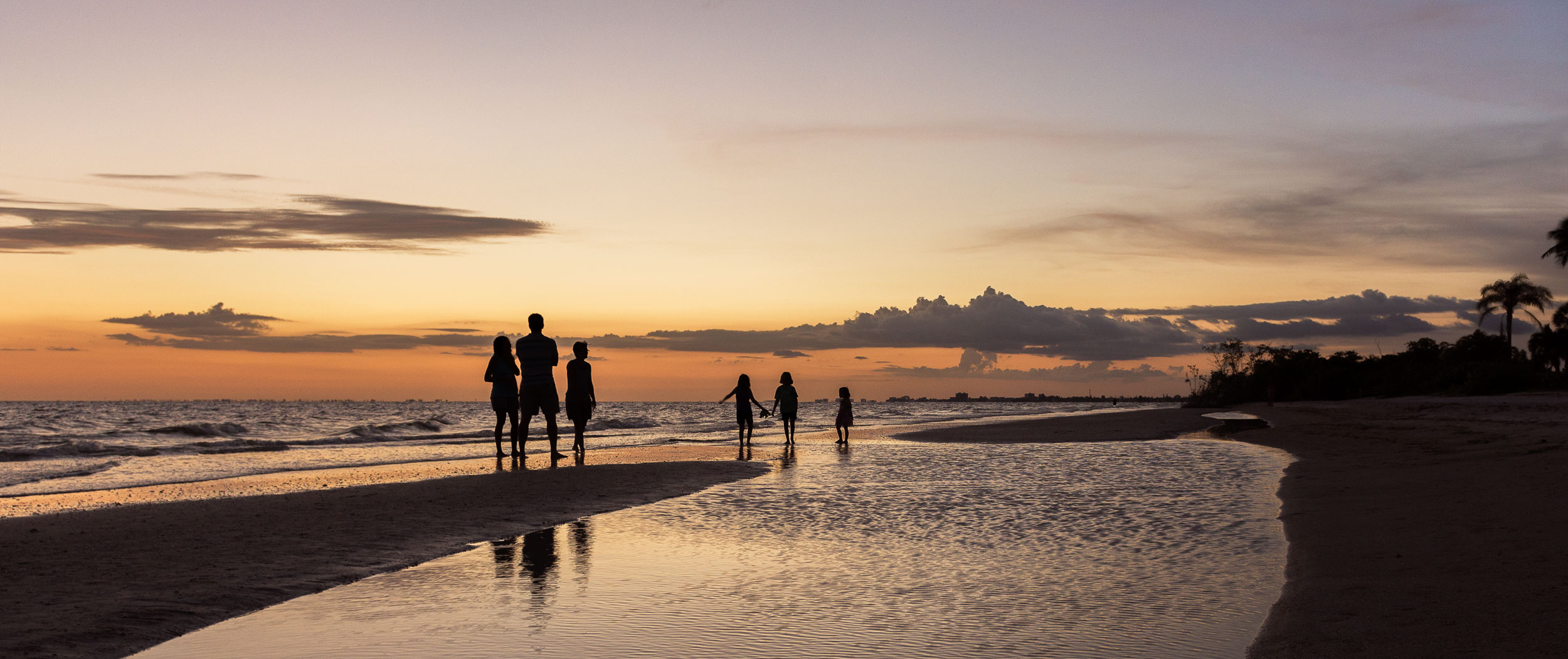 family at sunset playing on the beach_.jpg
