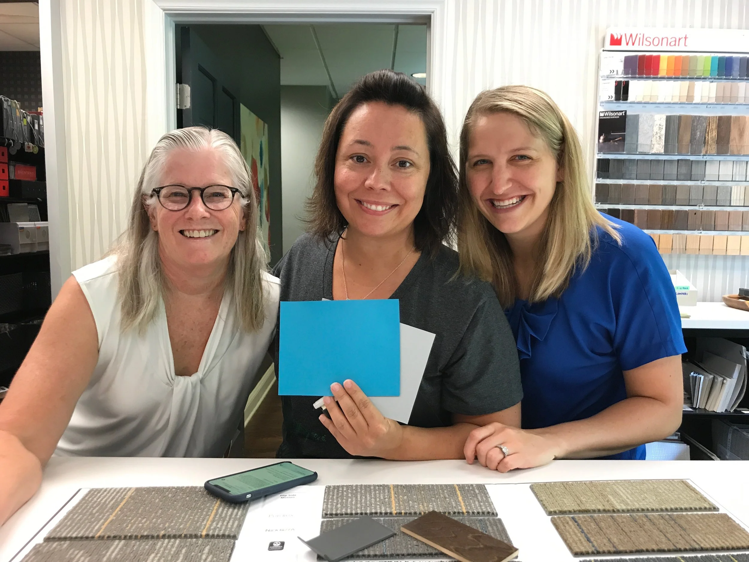 From left to right: Shawna, Kelly, and Holly select finishes for the new Cloud Giants headquarters.