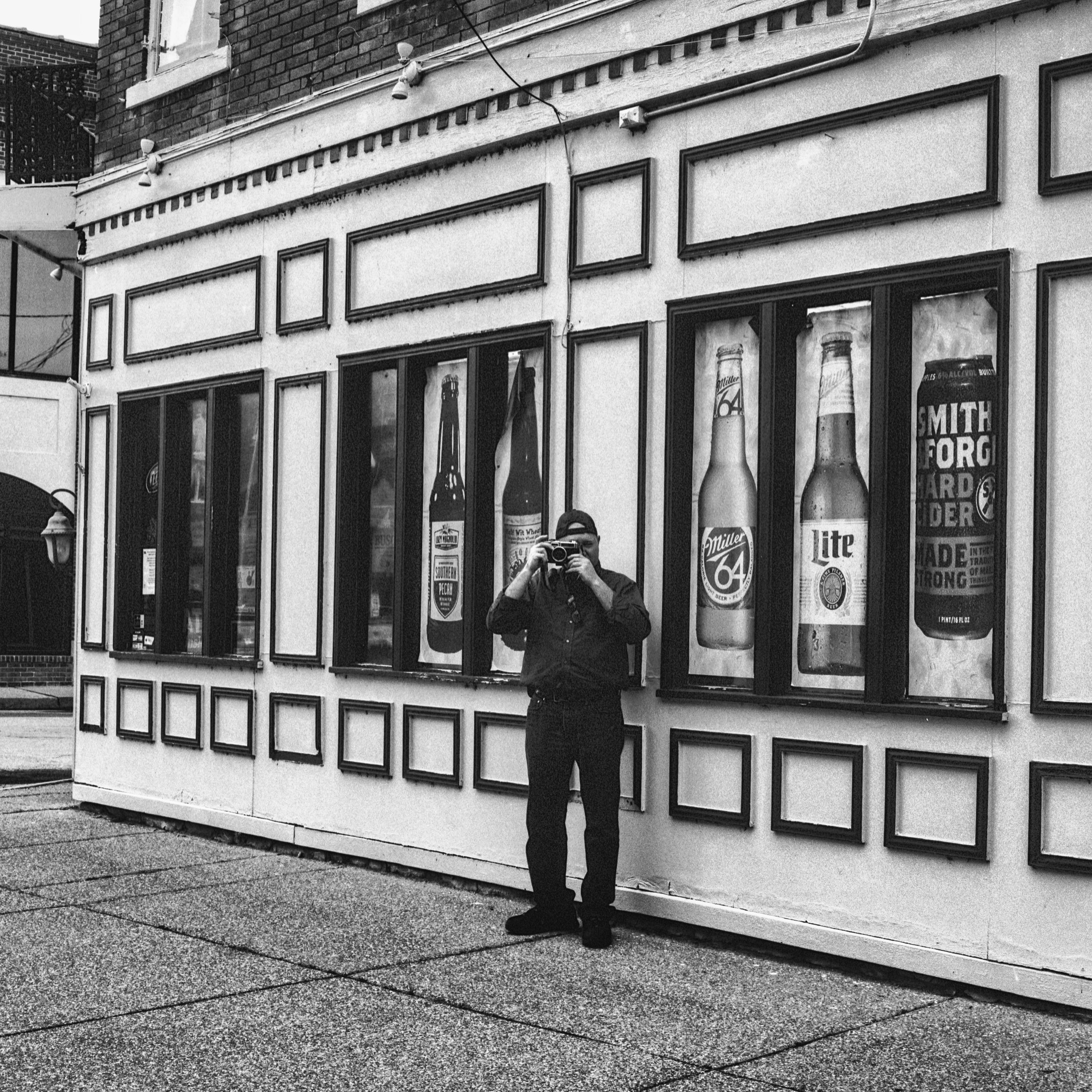 Photographer in Front of Bar