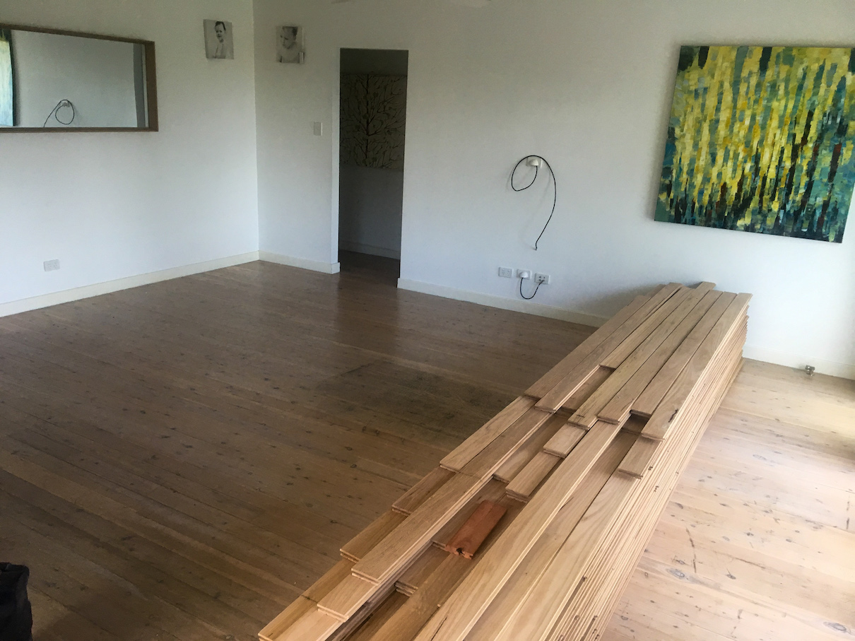 New Blackbutt flooring ready to cover the old Cypress Pine boards.