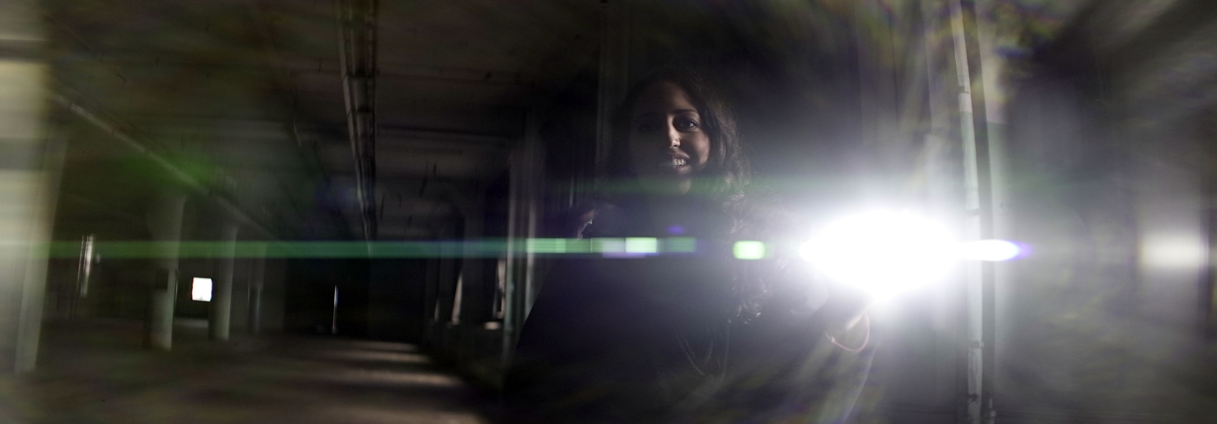 Elite 24.5mm anamorphic | Warehouse, Cleveland, OH - Lens flare triggered by Olivia Otten with the Nitecore P12 flashlight. Image captured wide open at T2.1. Image displayed full gate, 3.00:1. Photo by Keith Nickoson.