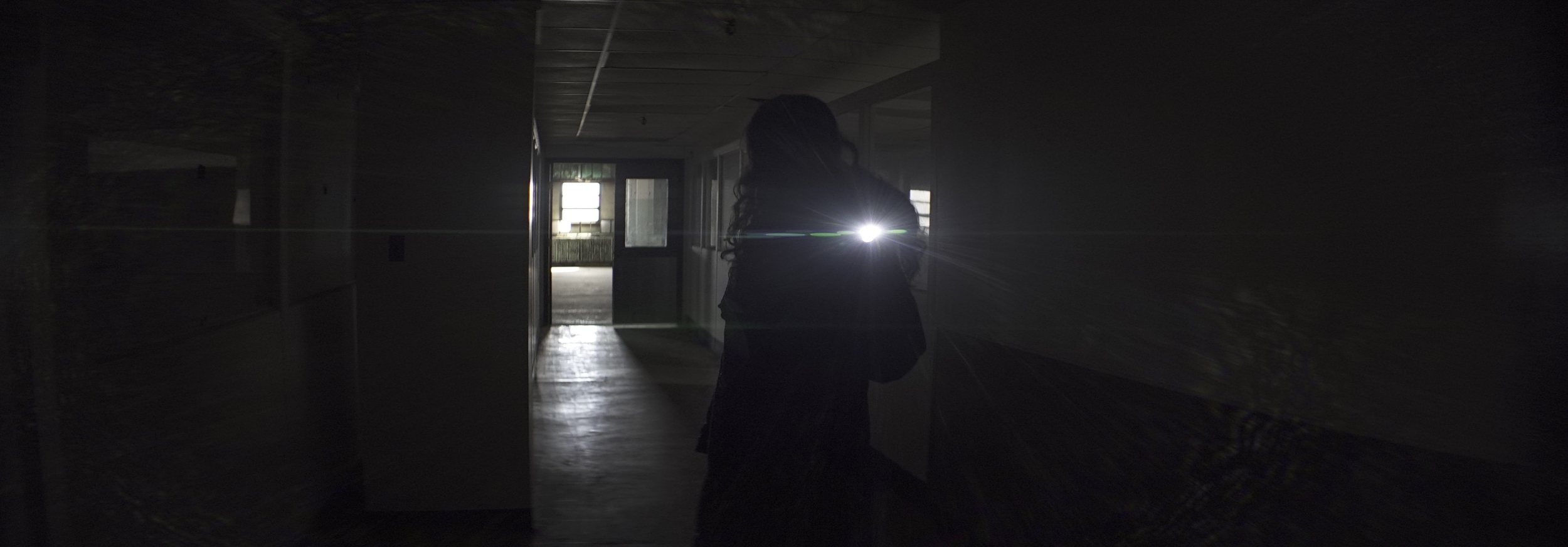 Elite 24.5mm anamorphic | Warehouse, Cleveland, OH - Lens flare triggered by Olivia Otten with the Nitecore P12 flashlight. Image captured wide open at T2.1. Image displayed full gate, 3.00:1. Photo by Keith Nickoson.