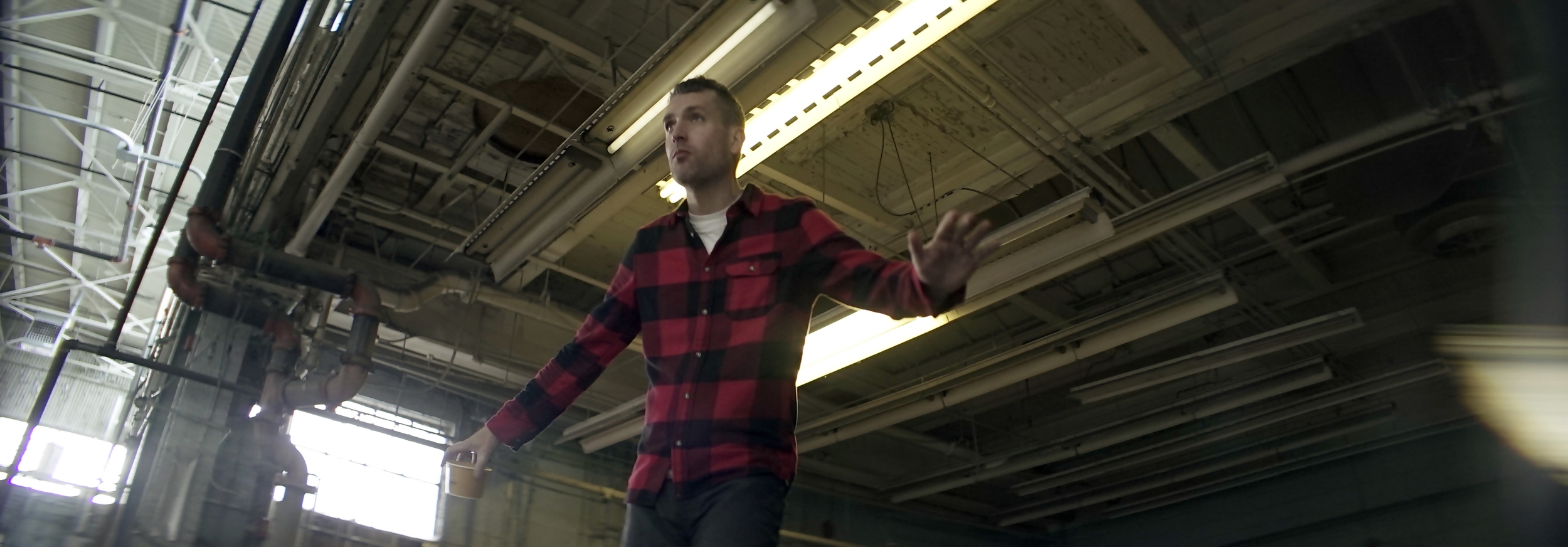 Elite 24.5mm anamorphic | Warehouse, Cleveland, OH - Director Ryan Scott surfing. This image displayed full-gate, 3.00:1, T2.1. Photo by Keith Nickoson.